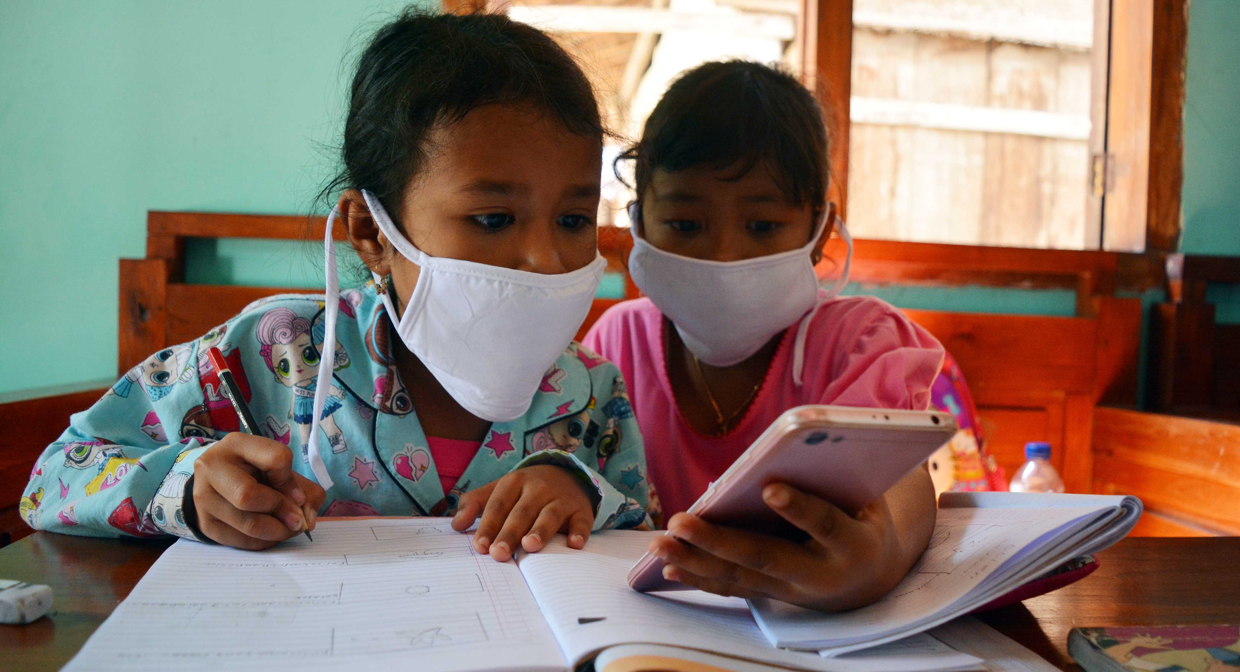 Siswa melakukan pembelajaran jarak jauh dengan ponsel