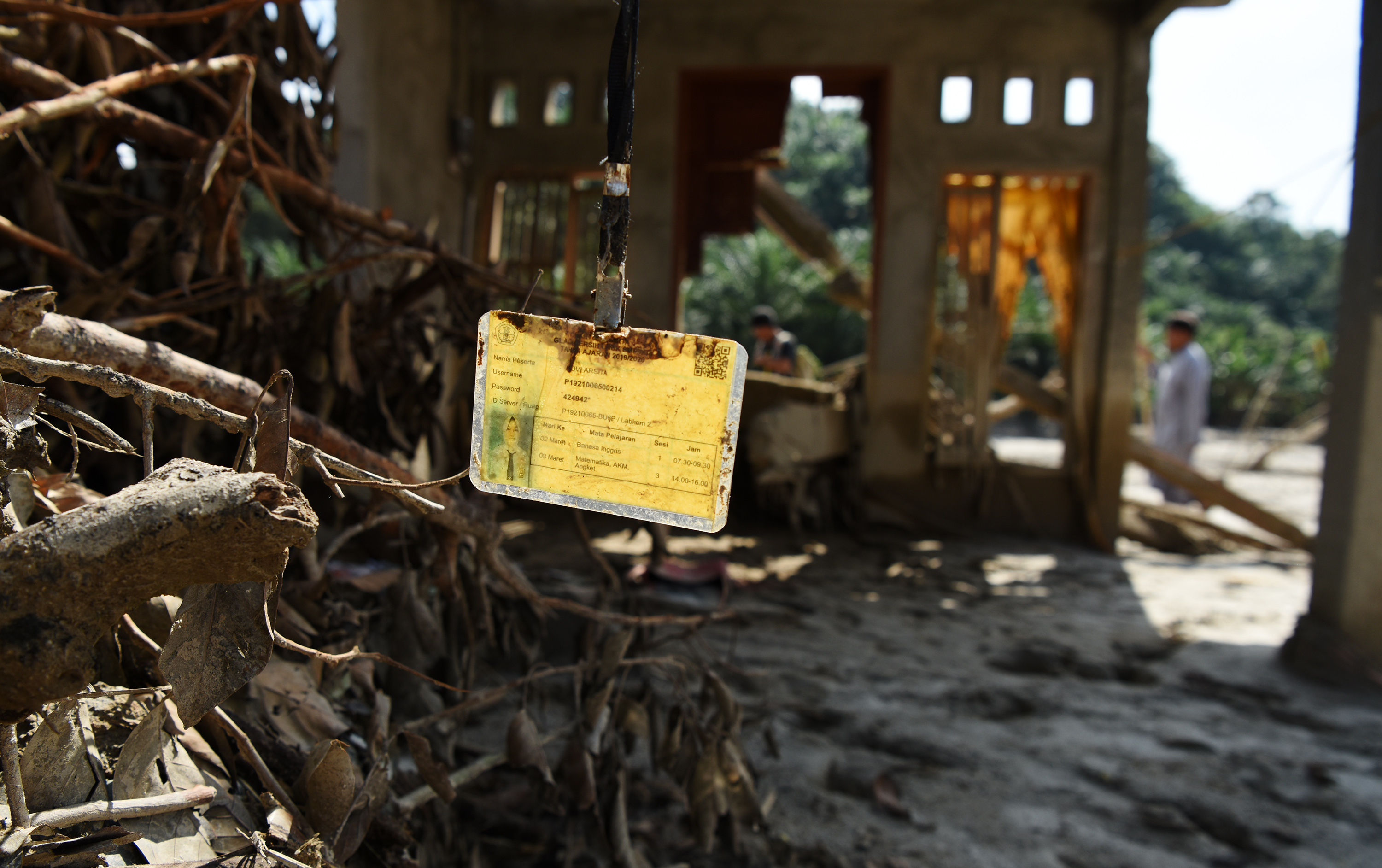 Warga melintas di rumah yang rusak akibat diterjang banjir bandang di Desa Petambua Masamba, Luwu Utara, Sulawesi Selatan, Rabu (22/7).