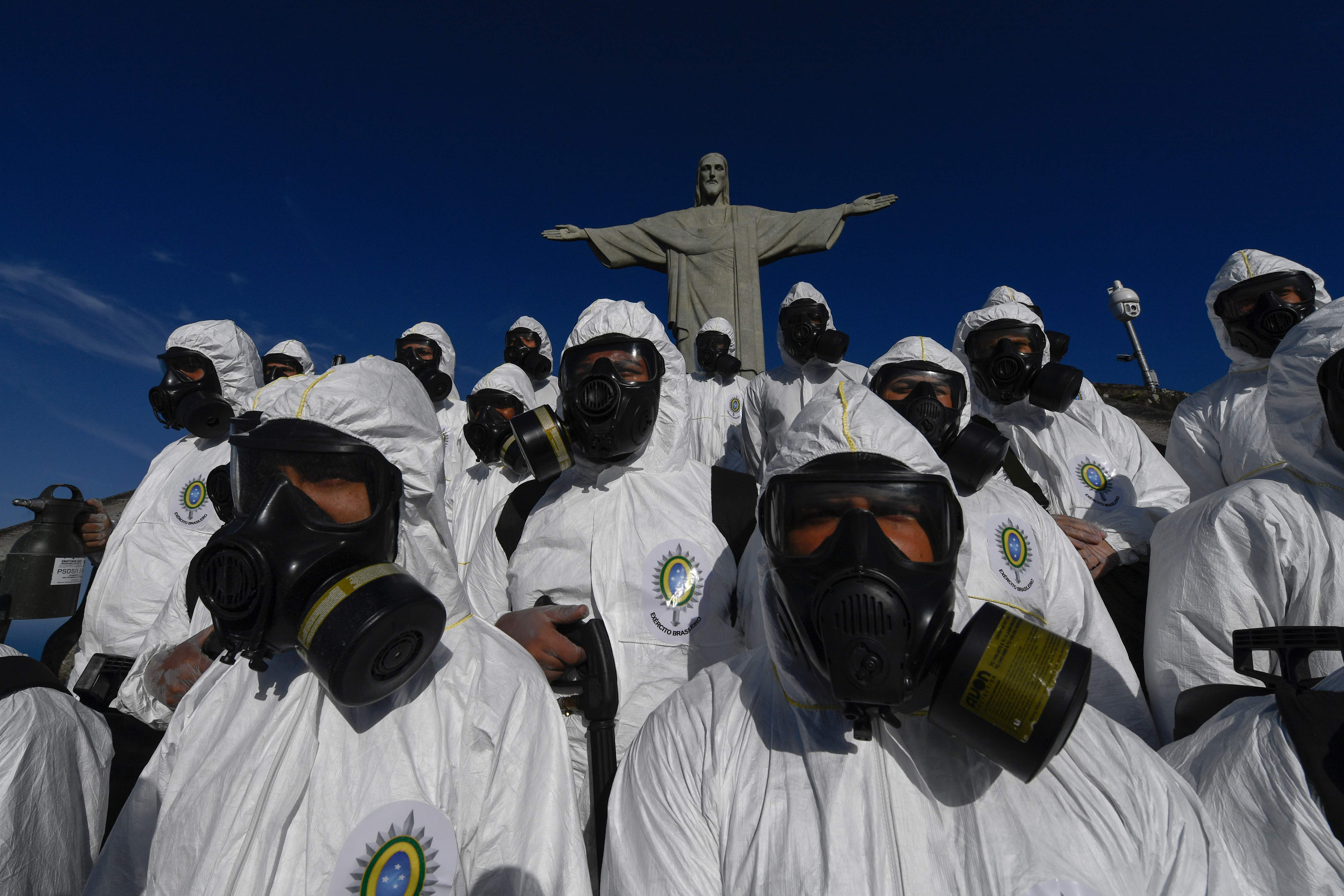 Brazilian Armed Forces memakai APD saat membersihkan patung Yesus di Rio de Janeiro, Brasil pada 13 Agustus 2020