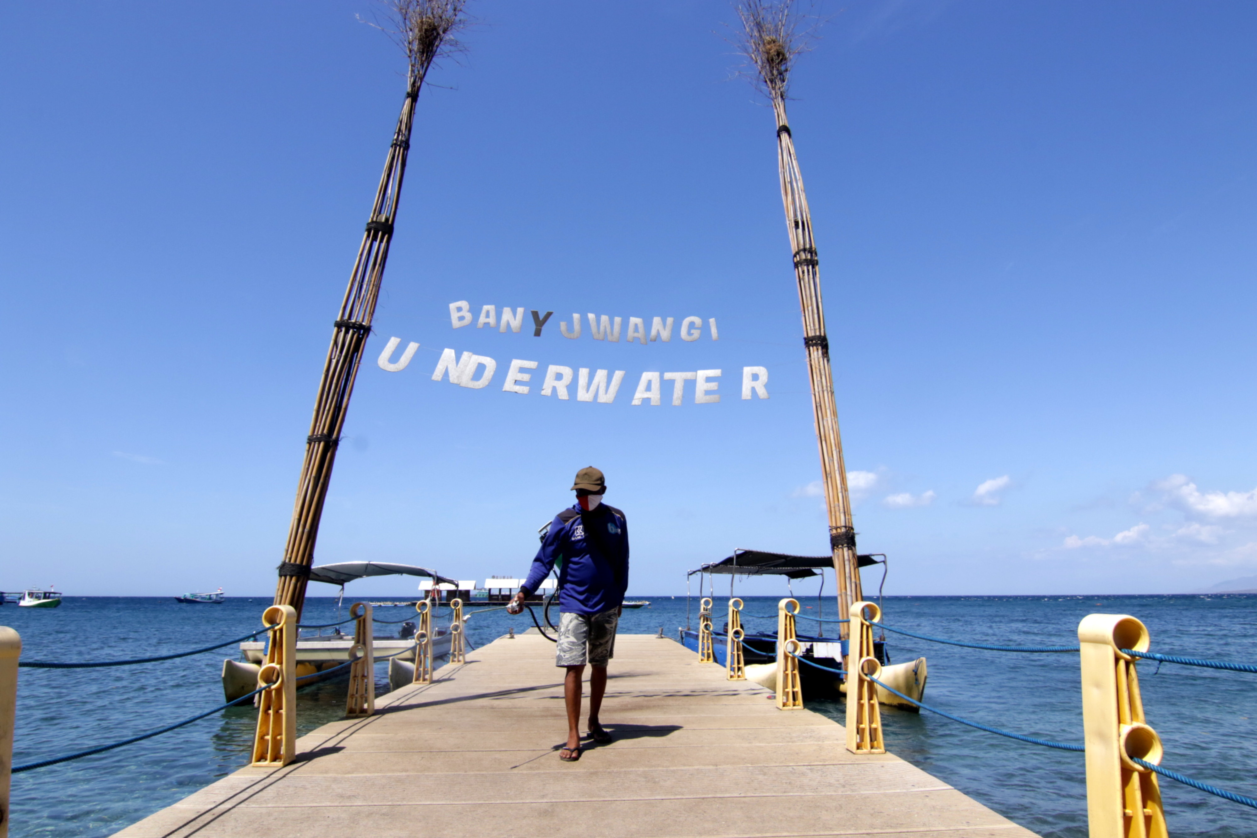  Petugas menyemprotkan cairan disinfektan di kawasan Pantai Bangsring, Banyuwangi, Jawa Timur, Senin (21/9/2020)