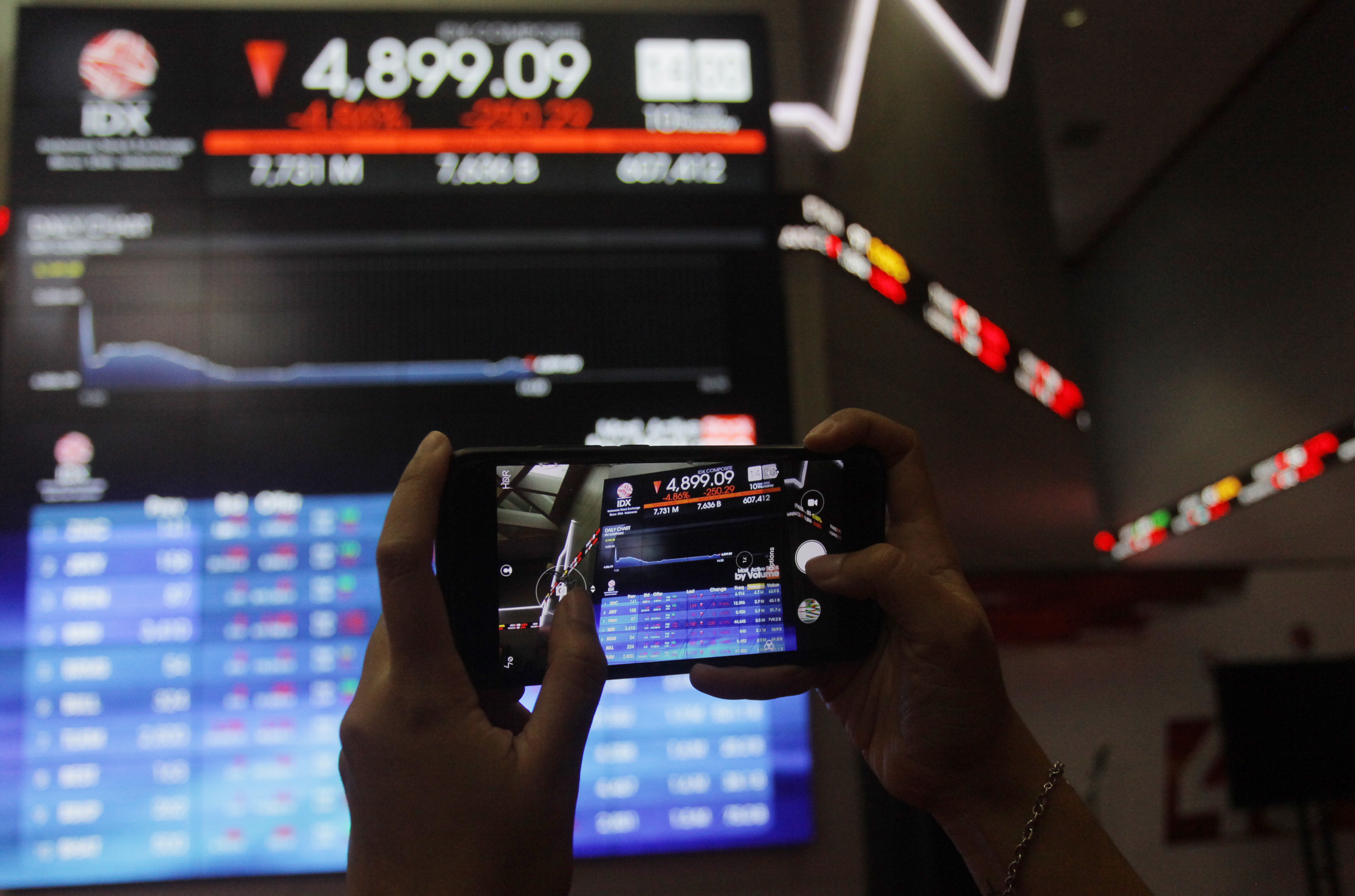 Karyawan mengamati layar pergerakan IHSG di Bursa Efek Indonesia.