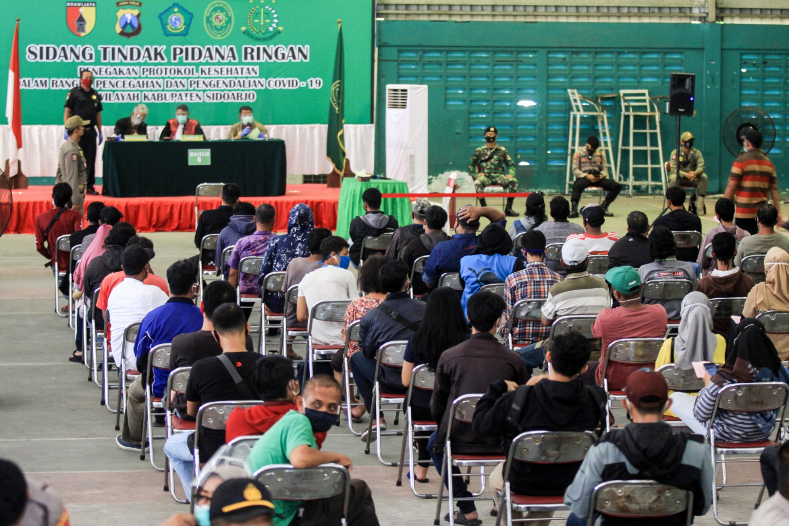 Pelanggar protokol kesehatan mengikuti sidang tindak pidana ringan di GOR Tennis Indoor Sidoarjo, Jawa Timur, Kamis (24/9).
