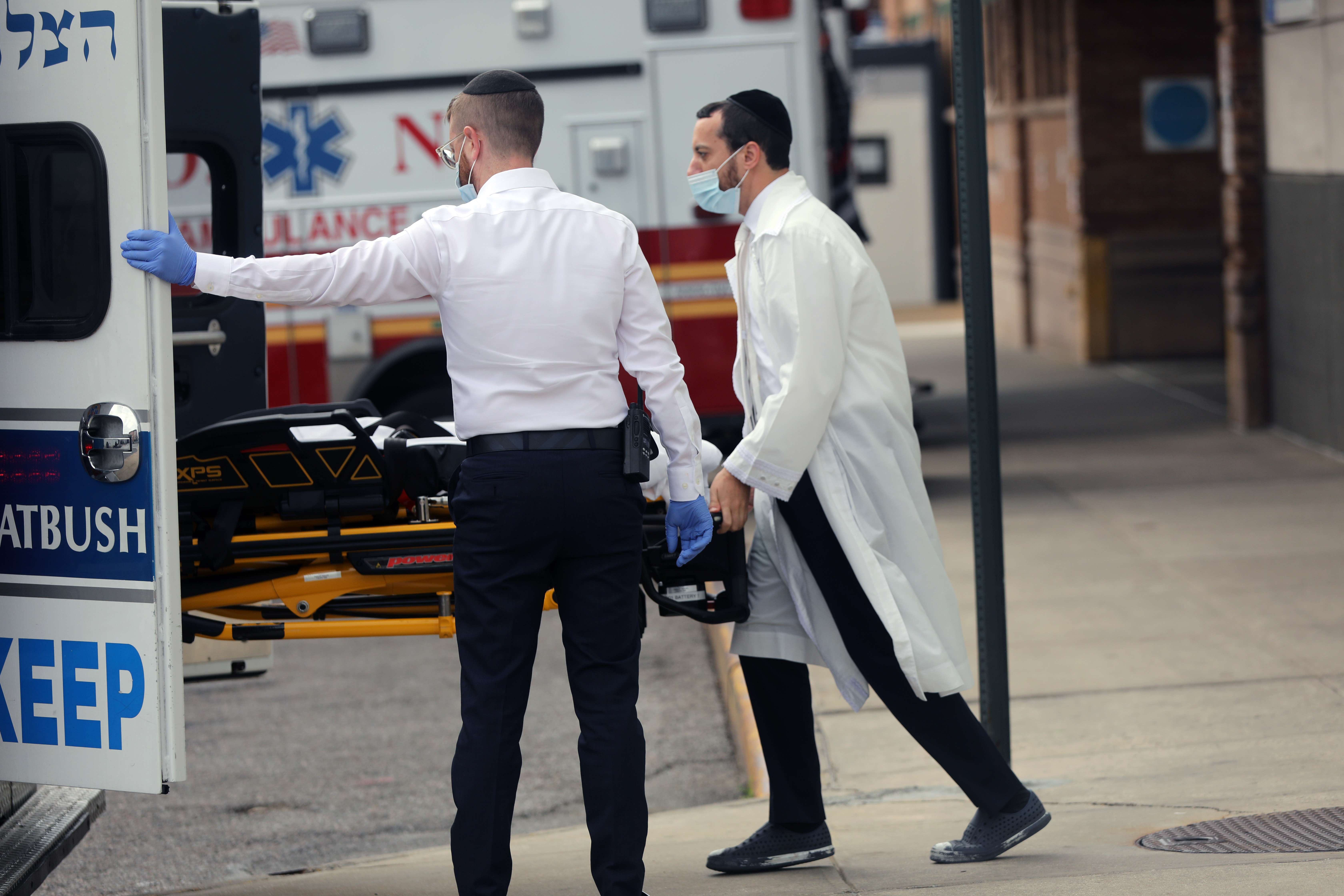 Petugas kesehatan membawa pasien positif covid-19 di Kota New York, AS, Senin (28/9/2020)