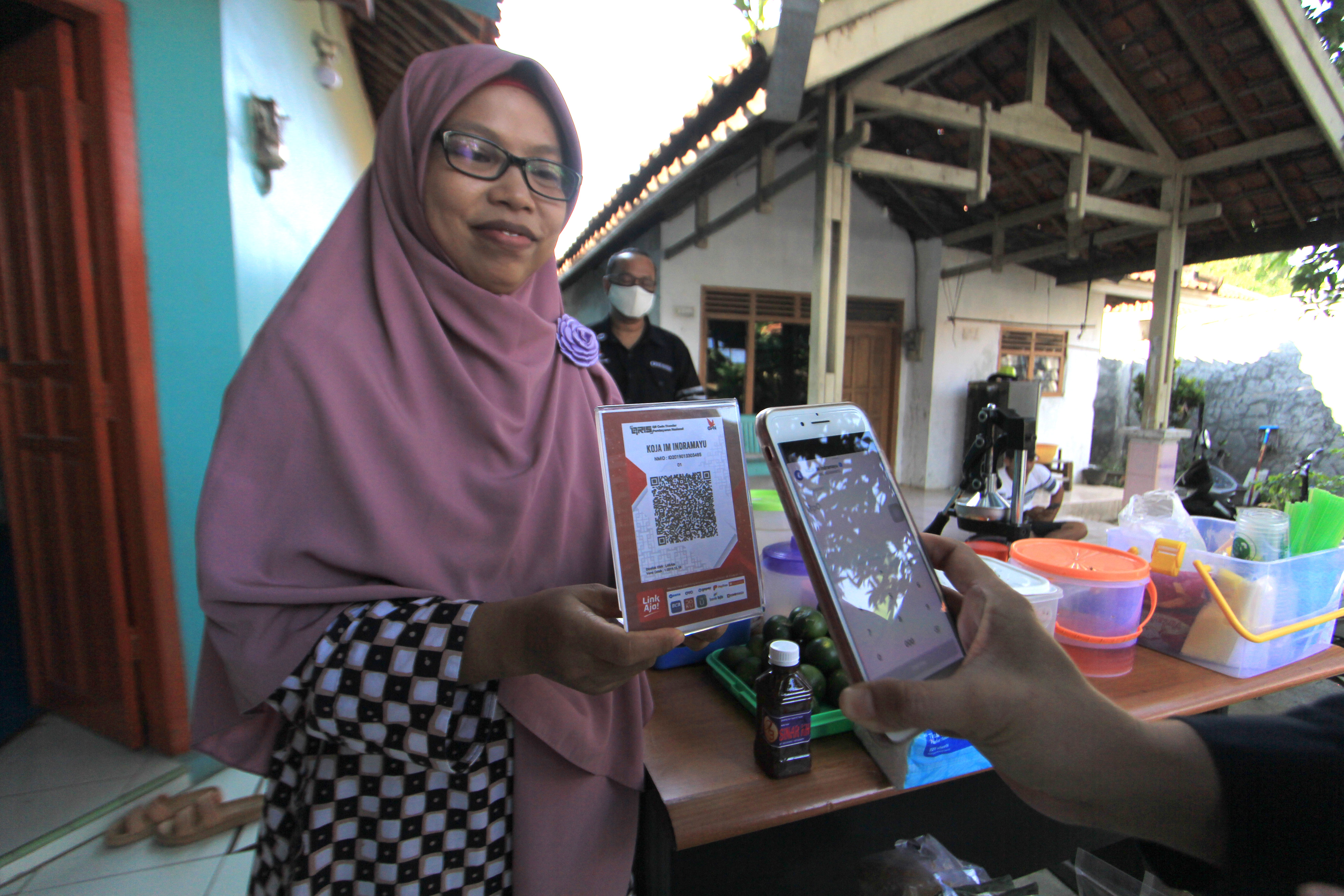 Petugas Bank Indonesia Cirebon menunjukan transaksi melalui aplikasi elektronik di Desa Kenanga, Indramayu, Jawa Barat.