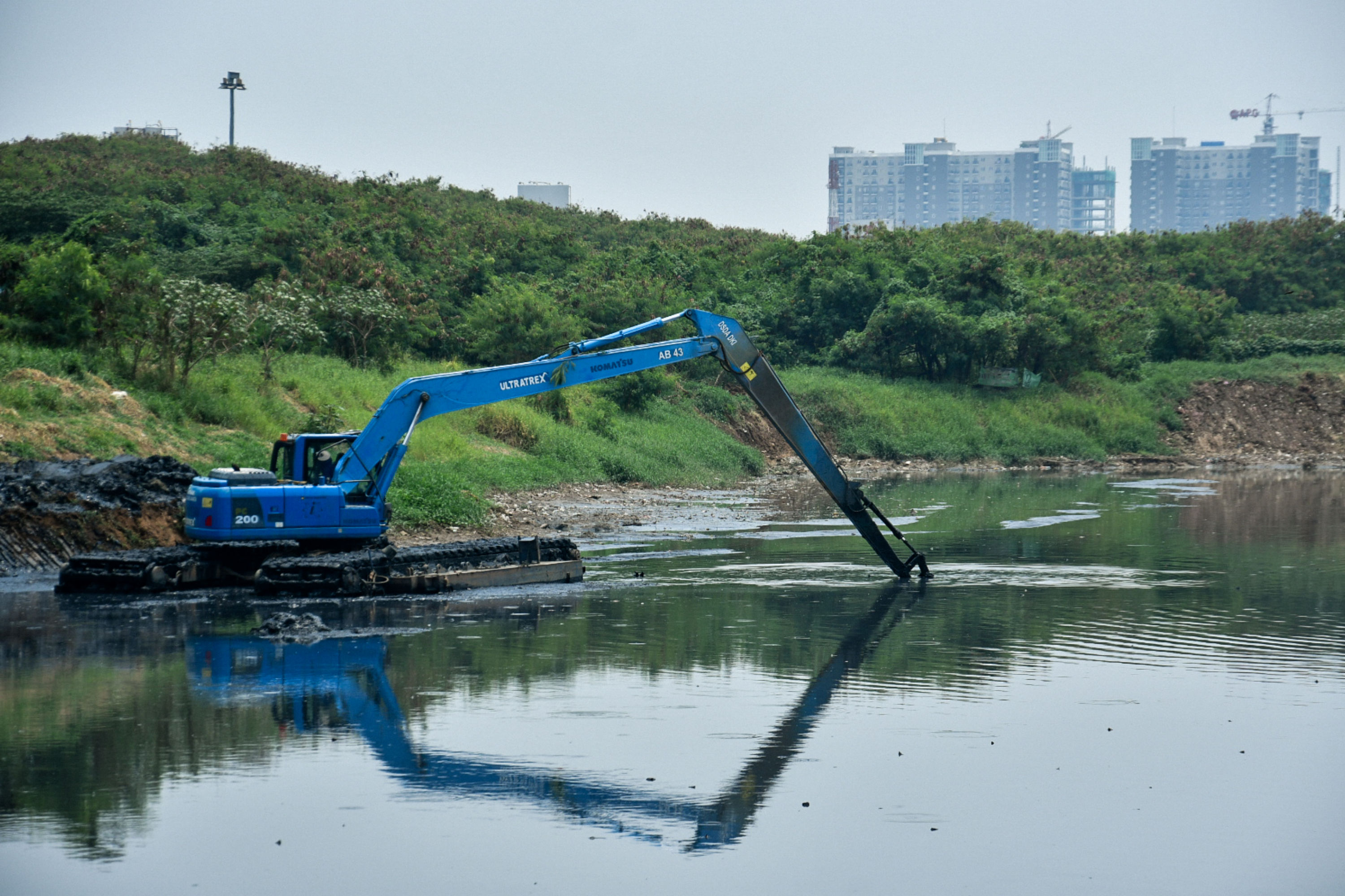  Petugas mengoperasikan alat berat saat pengerukan lumpur di Waduk Ria Rio, Jakarta.
