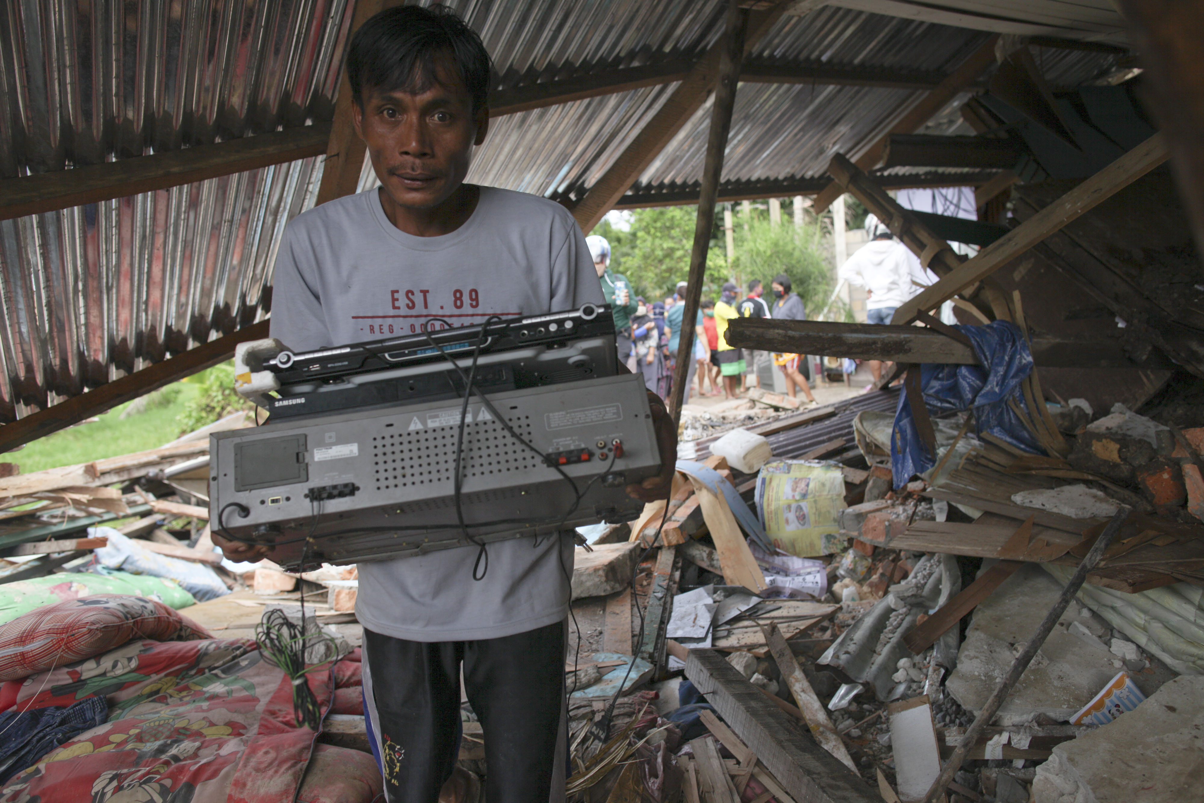Seorang warga mencari harta benda yang masih bisa diselamatkan setelah rumahnya hancur terkena tanah longsor di Tarakan