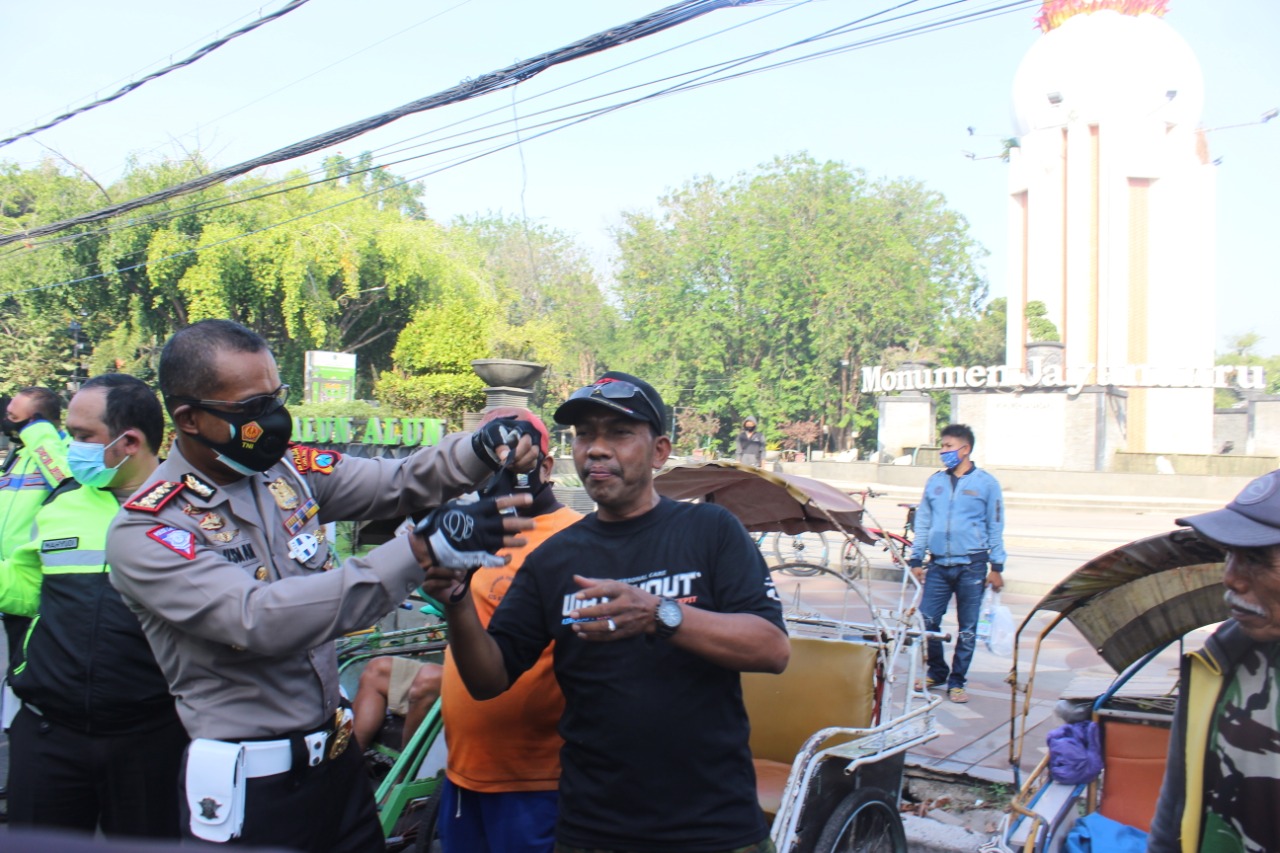 Dirlantas Polda Jatim Kombes Latif Usman membagikan masker ke masyarakat Sidoarjo. 