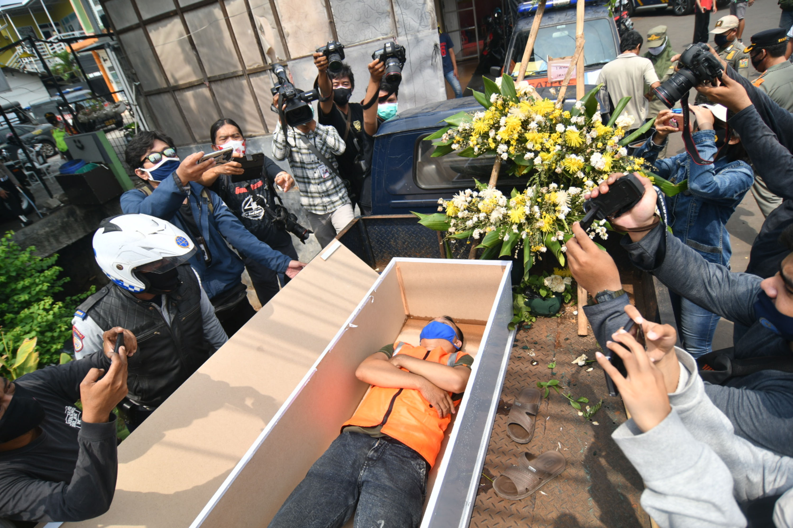 Warga pelanggar PSBB dihukum masuk peti mati di kawasan Pasar Rebo, Jakarta.