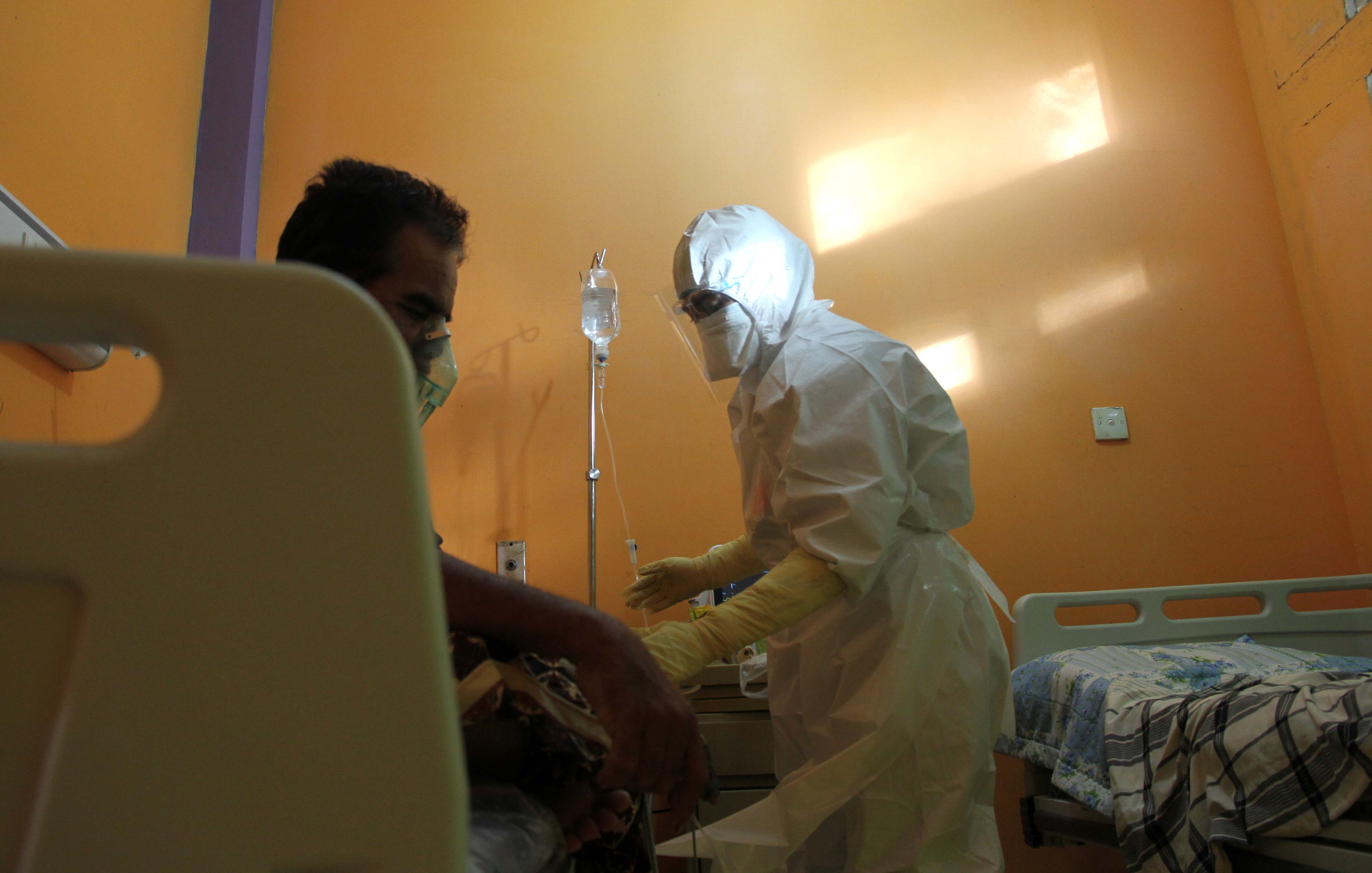 Petugas medis (kanan) merawat pasien di ruang rawat isolasi covid-19 Rumah Sakit Umum Daerah-Cut Nyak Dhien, Meulaboh, Aceh.