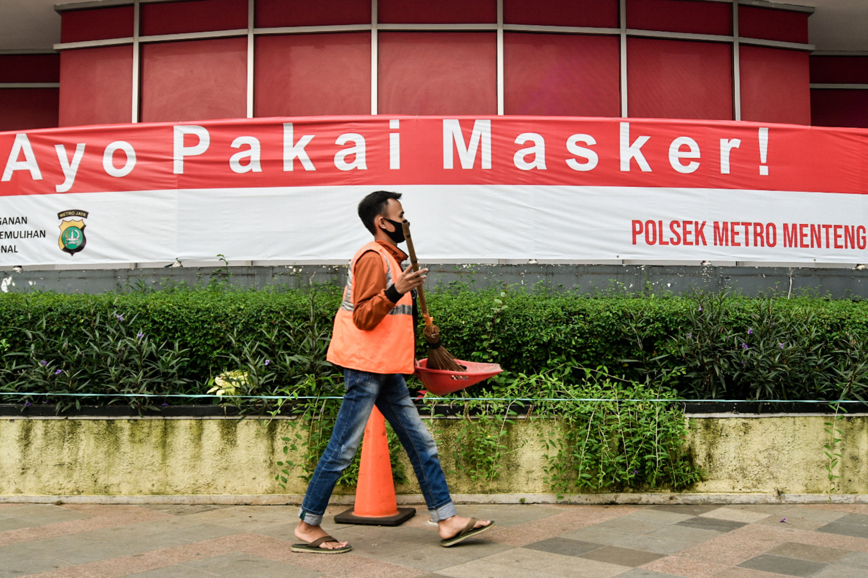 Seorang warga menjalani saksi sosial karena terjaring operasi yustisi PSBB jilid II.