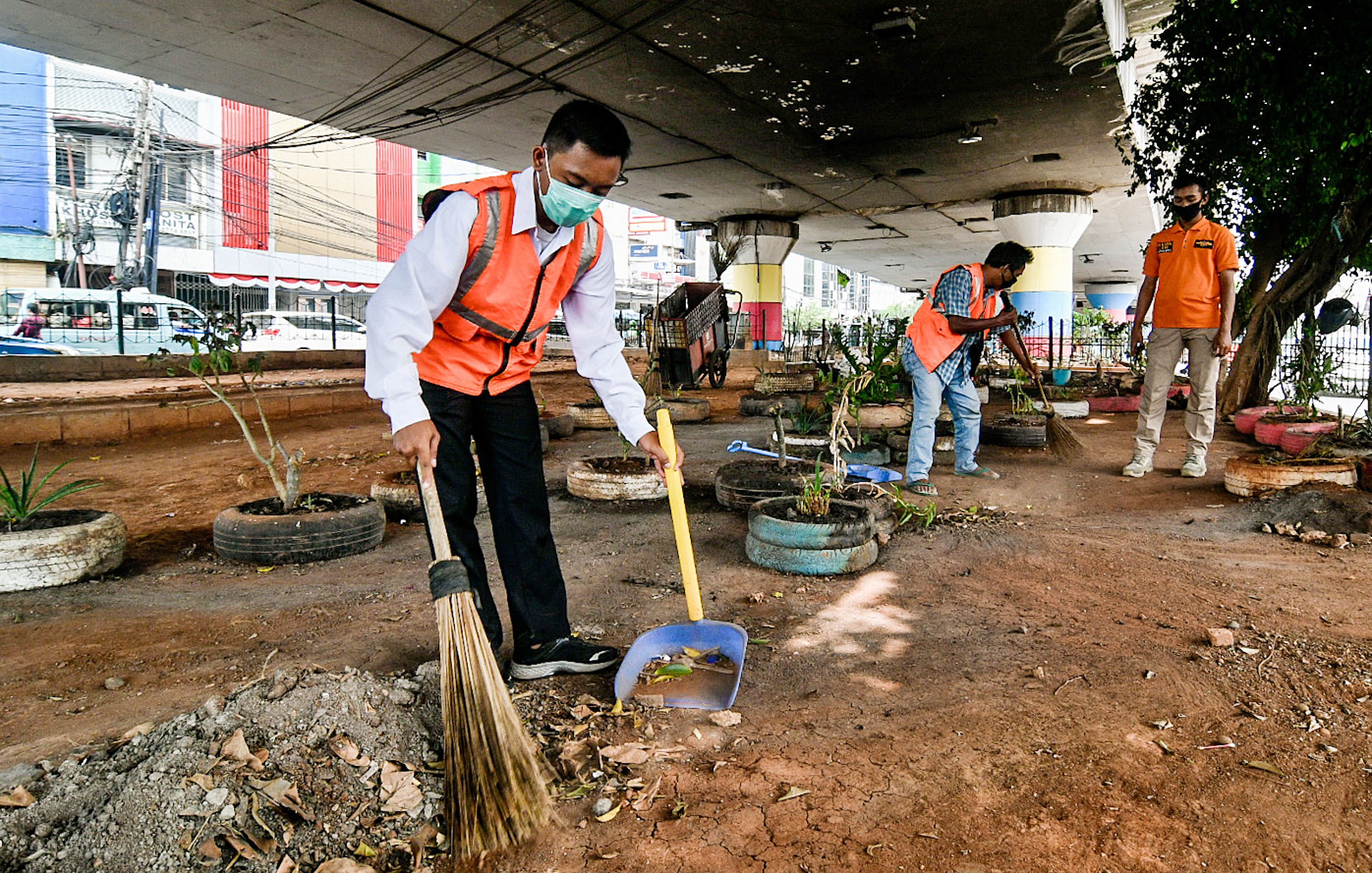 Warga yang terjaring razia masker dikenakan sangsi sosial di Kawasan Kampung Melayu, Jakarta.