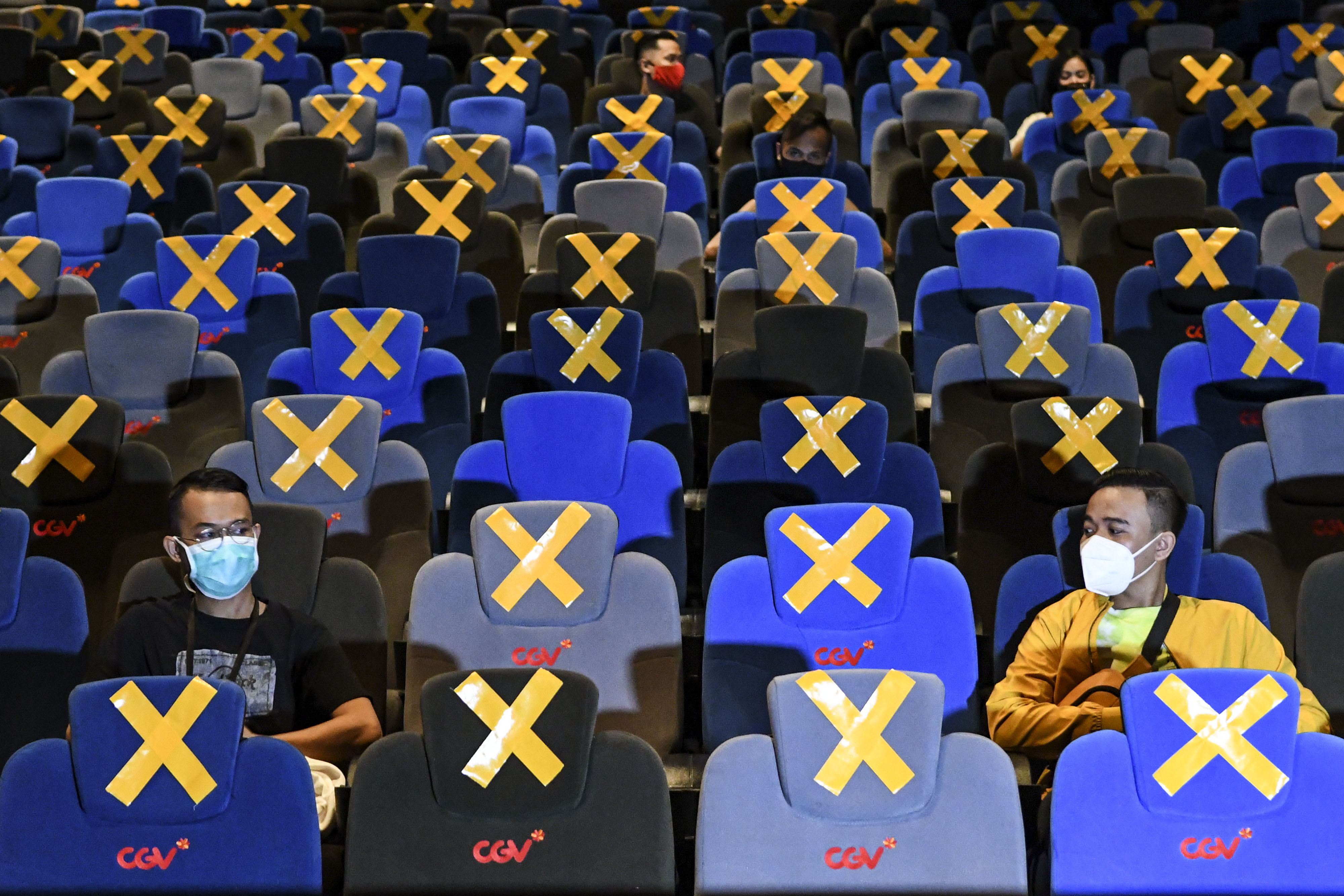 Pengunjung berbincang saat akan menonton film di salah satu bioskop di Jakarta, Rabu (21/10/2020).