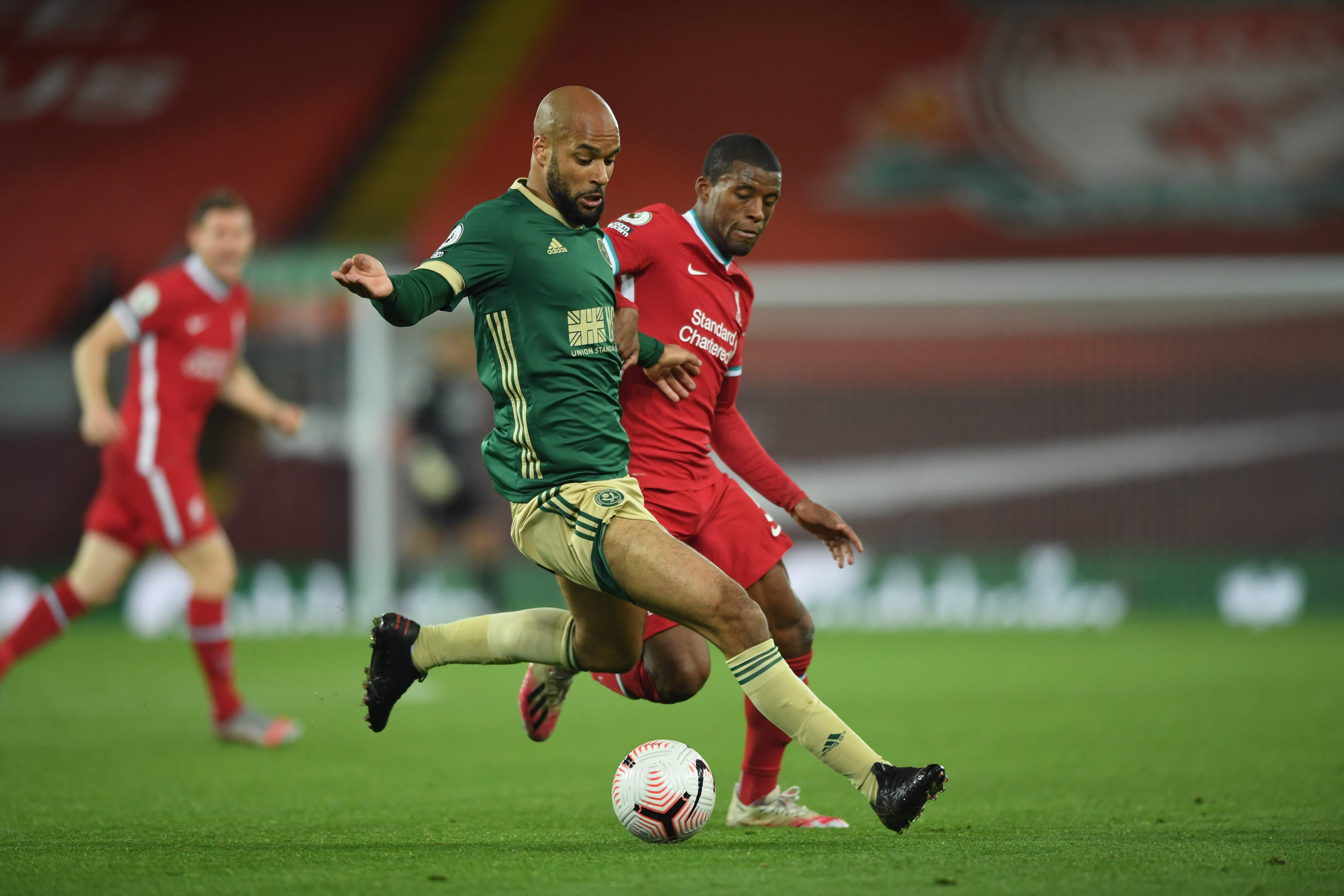 Gelandang Liverpool Georginio Wijnaldum berebut bola dengan striker Sheffield David McGoldrick