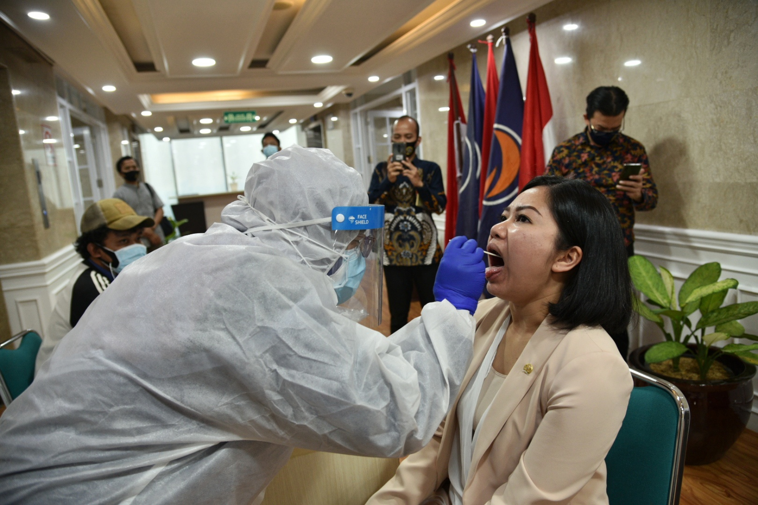 Petugas melakukan proses swab test kepada anggota fraksi NasDem di Gedung Nusantara 1, Kompleks DPR, Jakarta.