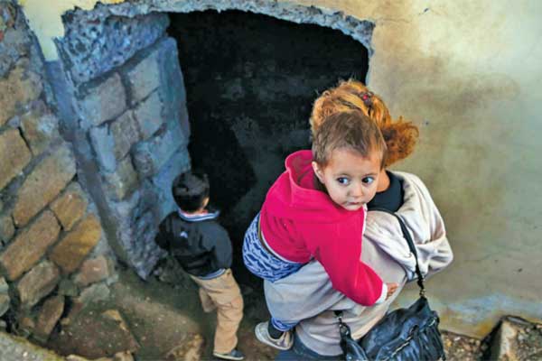 Seorang perempuan membawa anaknya ke tempat penampungan di bawah tanah di kota bersejarah Shusha, 