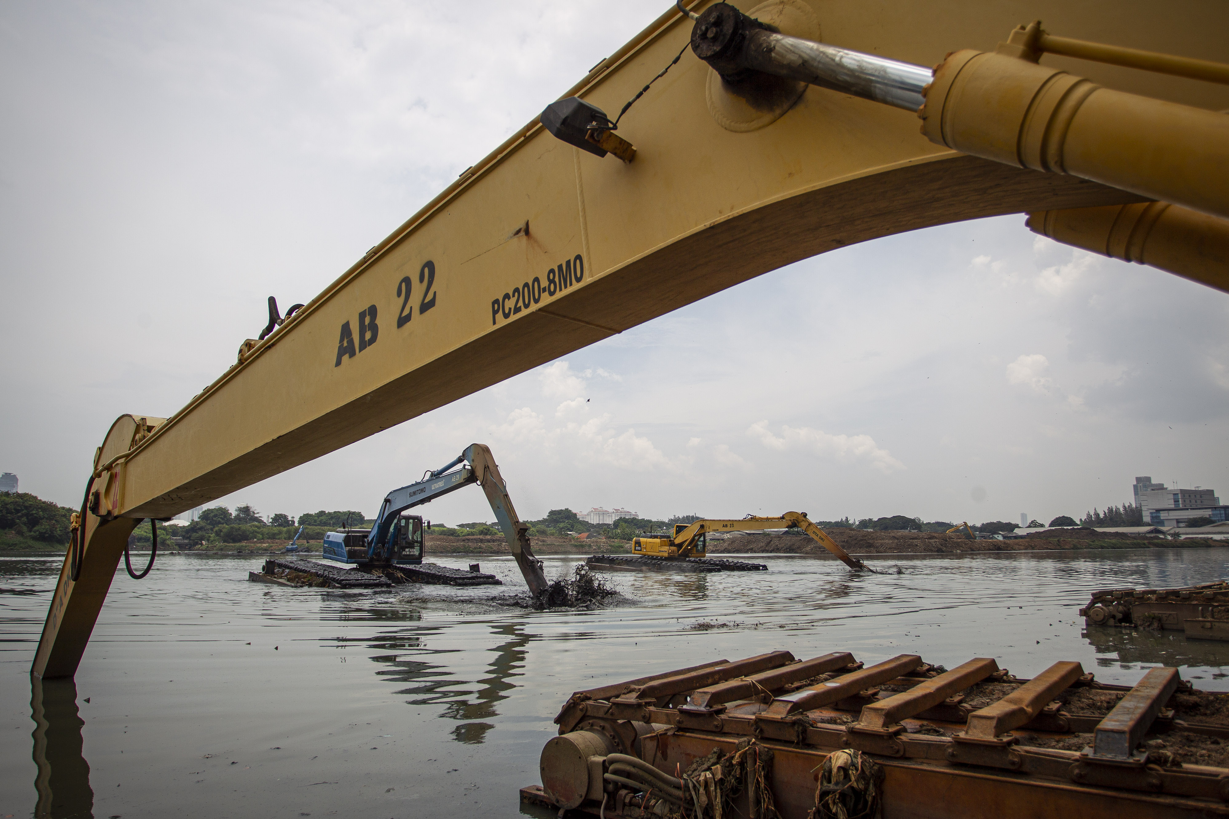 Petugas Dinas Sumber Daya Air (SDA) DKI Jakarta mengoperasikan alat berat untuk mengeruk endapan lumpur di Waduk Ria Rio, Jakarta.