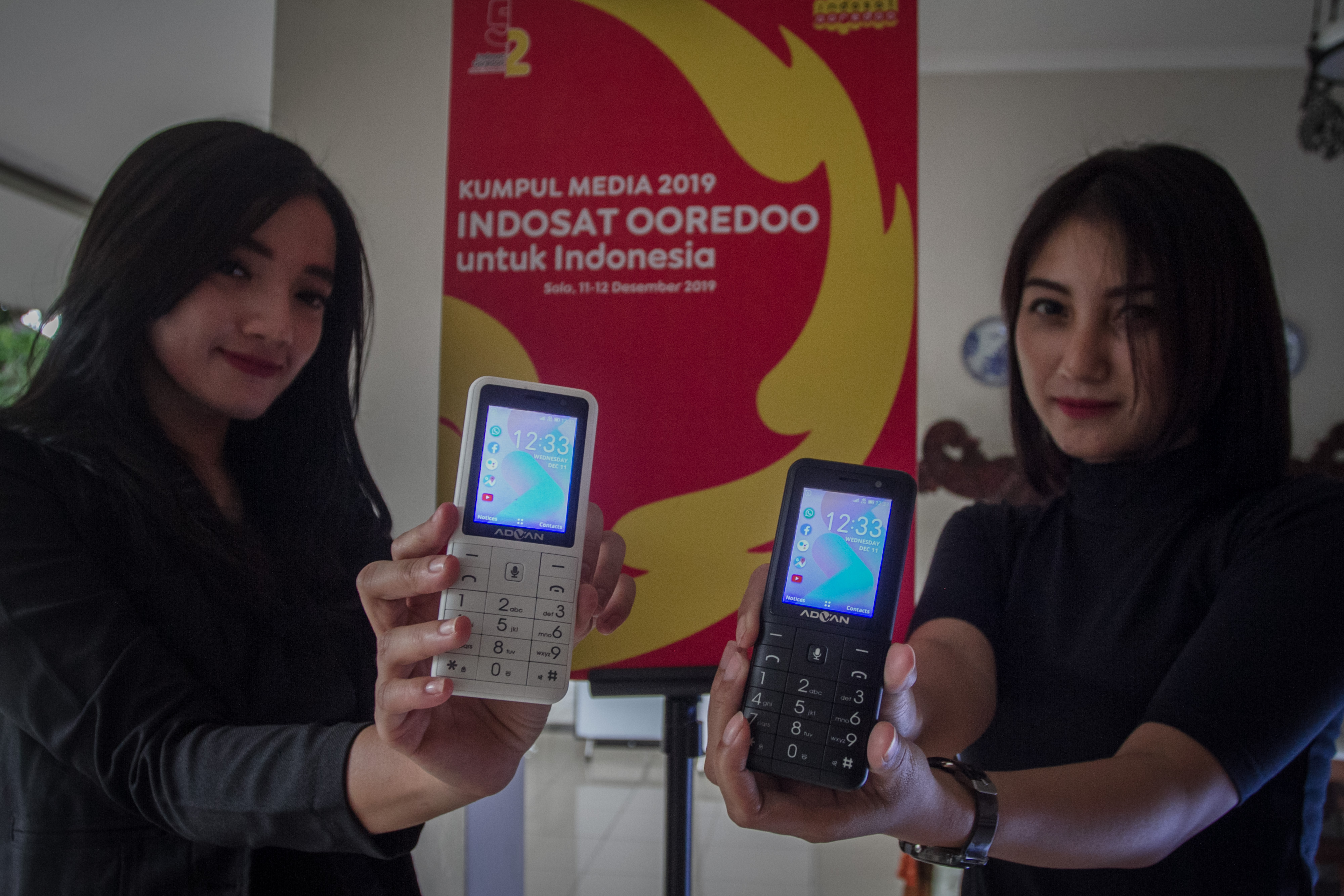Model menunjukan 4G Smart Feature Phone saat acara peluncurannya 