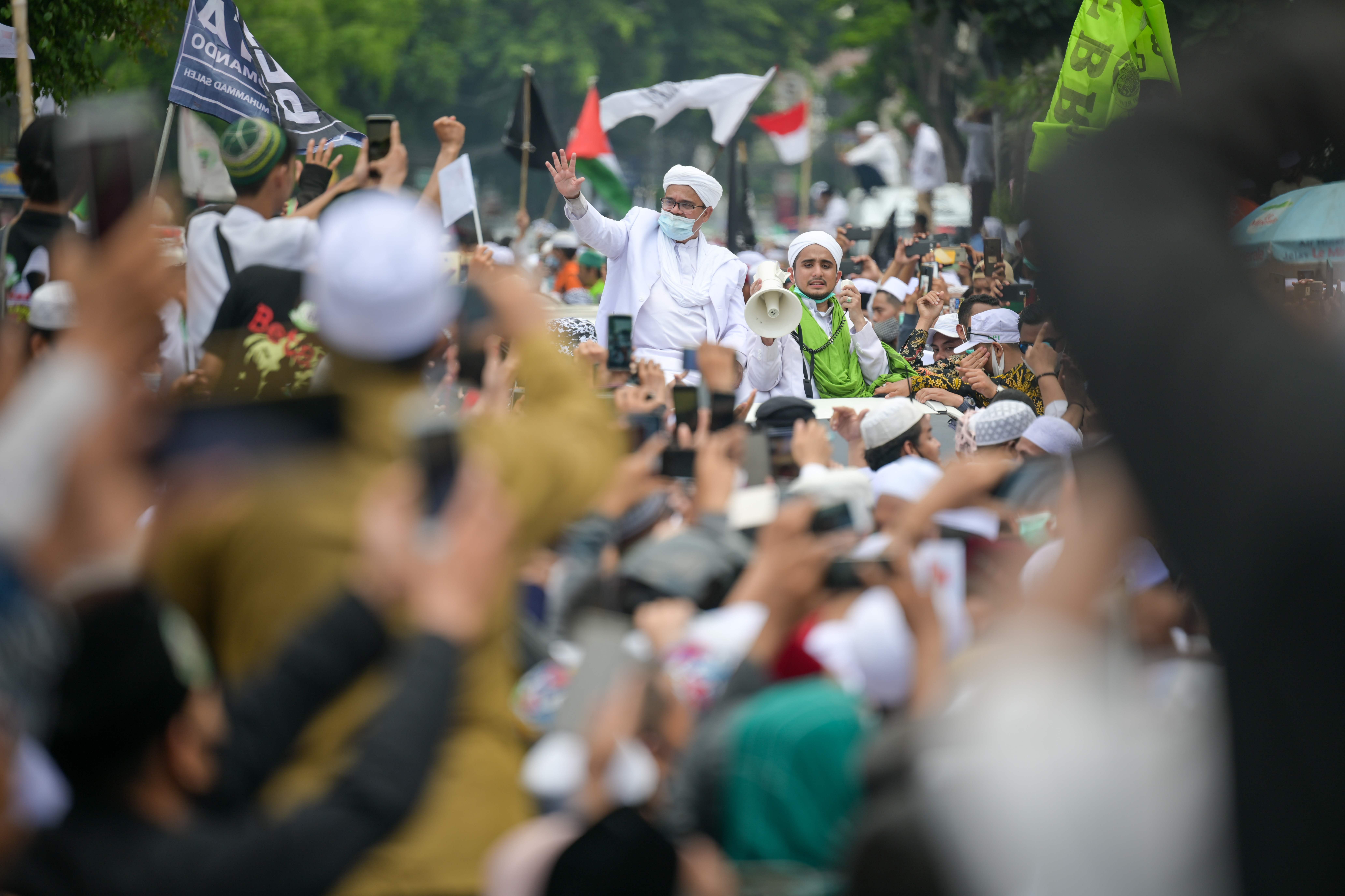 Kerumunan massa menyambut kedatangan Imam Besar FPI Rizieq Shihab.