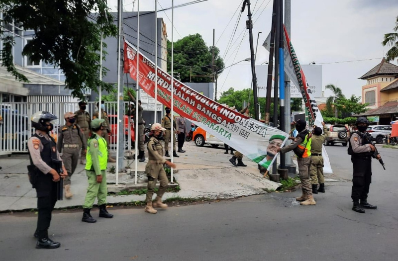 Petugas Satpol PP Kota Solo mencopoti spanduk dan baliho liar dalam operasi yustisi gabungan yang melibatkan unsur TNI-Polri.