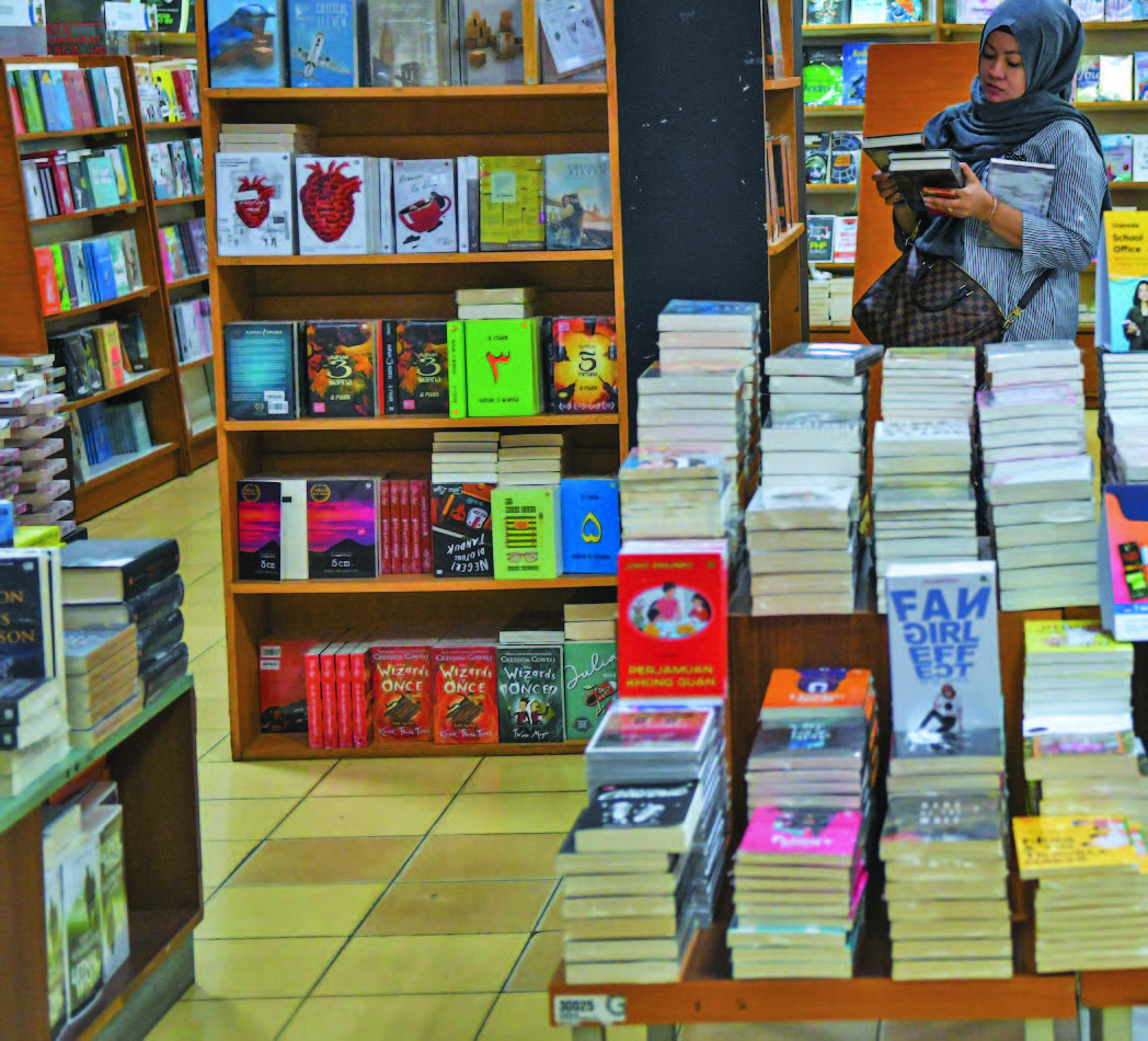PENGUNJUNG memilih buku yang dijual di sebuat toko buku di Palembang, Sumatra Selatan, Senin (24/2/2020).