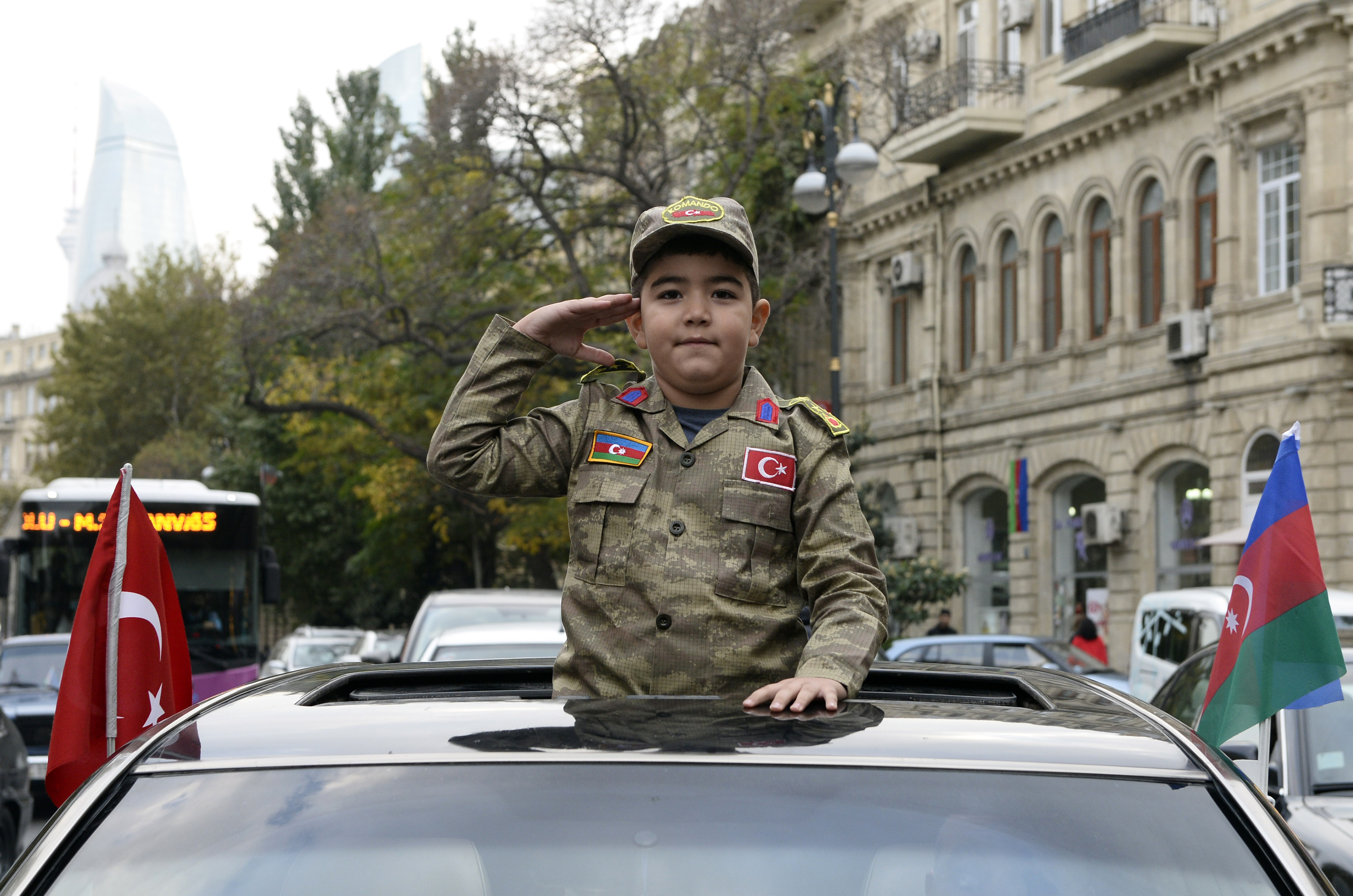 Seorang anak mengenakan pakaian militer Azerbaijan di Baku merayakan gencatan senjata di Nagorno-Karabakh.