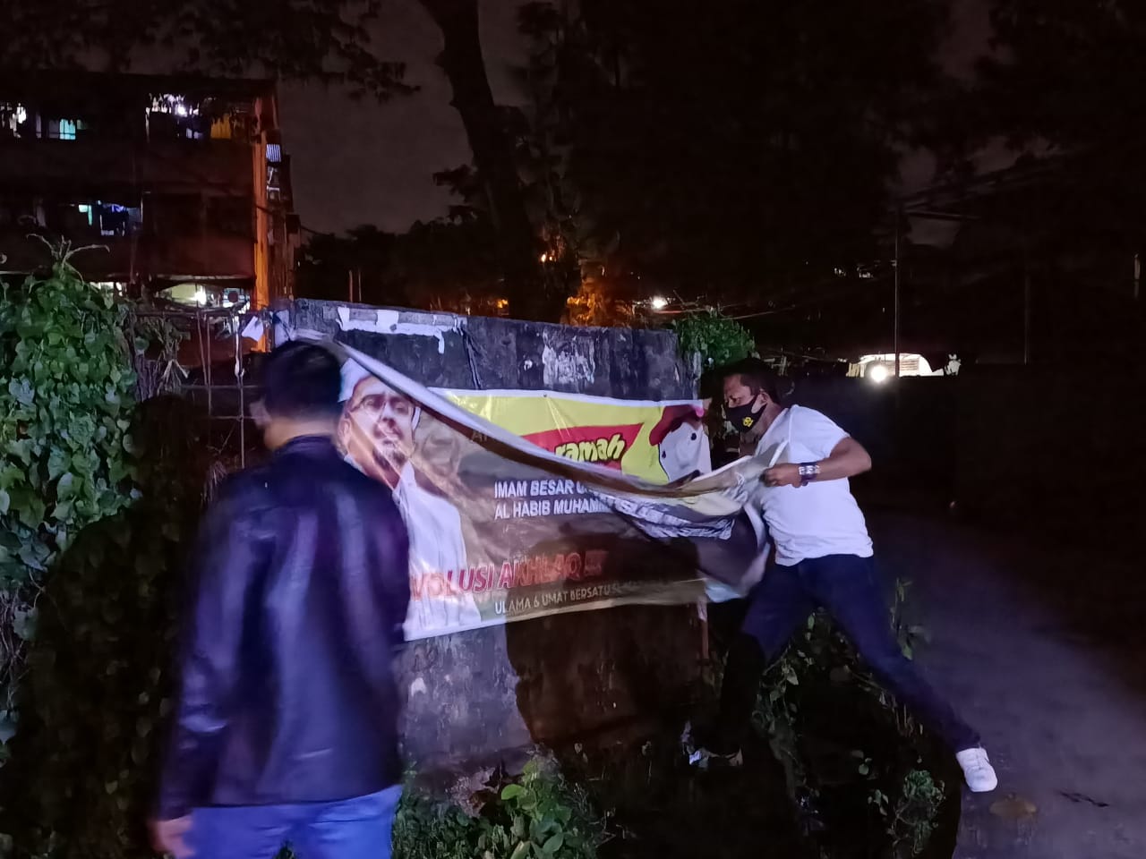 Suasana penurunan spanduk habib Riziq Shihab di Kota Palembang, Sumatera Selatan. 