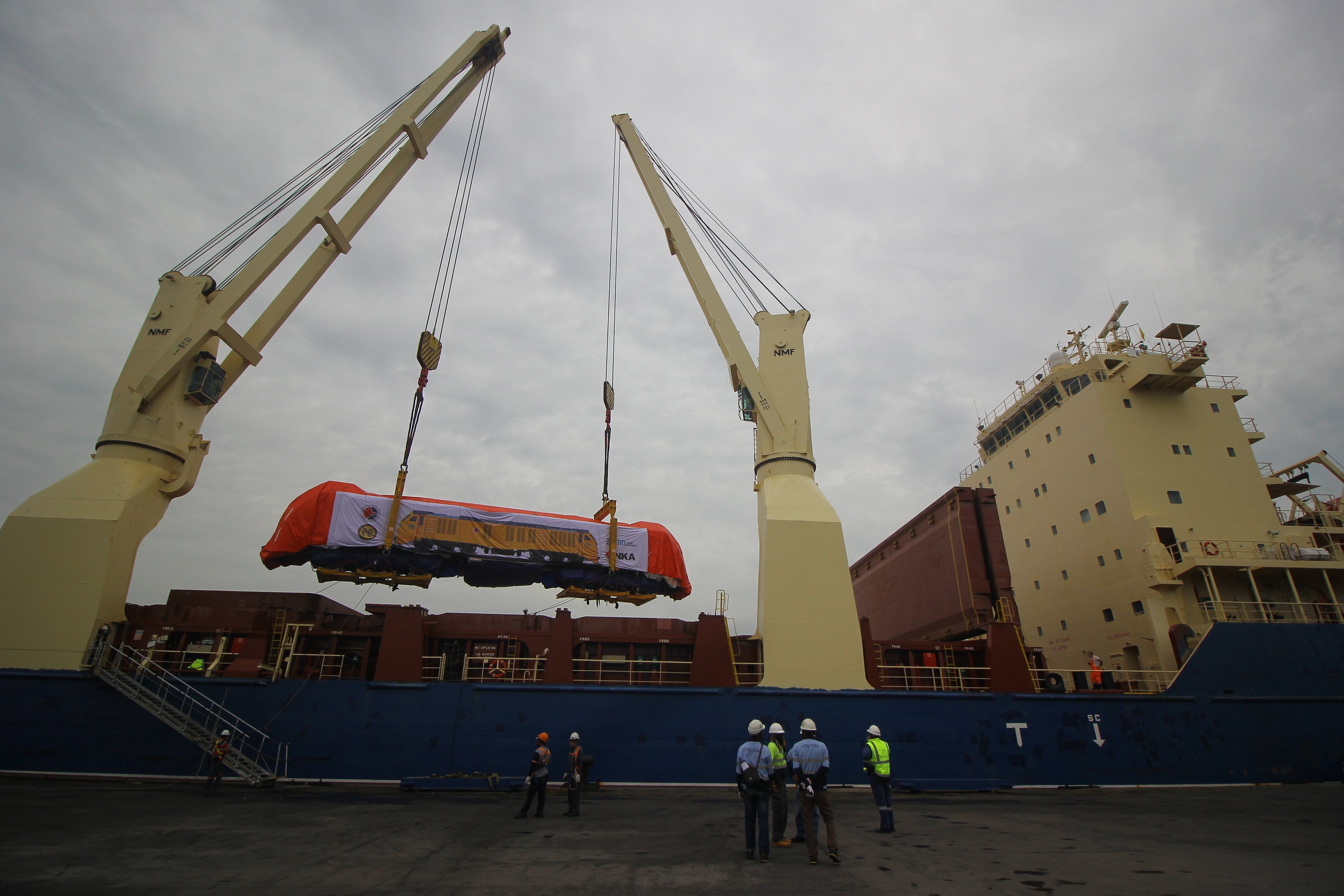 Pekerja melakukan proses pemuatan lokomotif buatan PT INKA (Persero) ke dalam kapal untuk diekspor ke Filipina