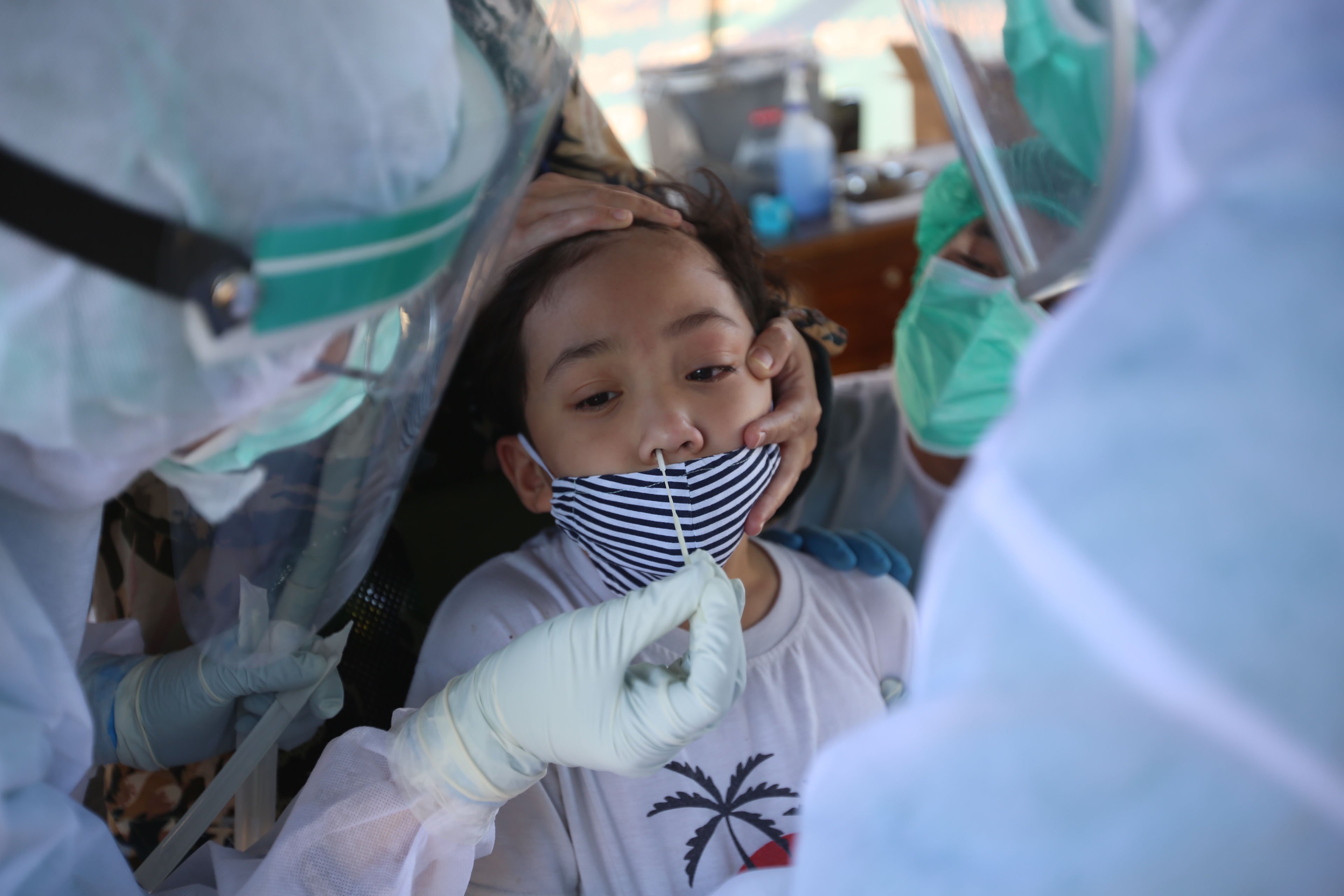 Petugas medis melakukan tes PCR ke warga di Jakarta Selatan