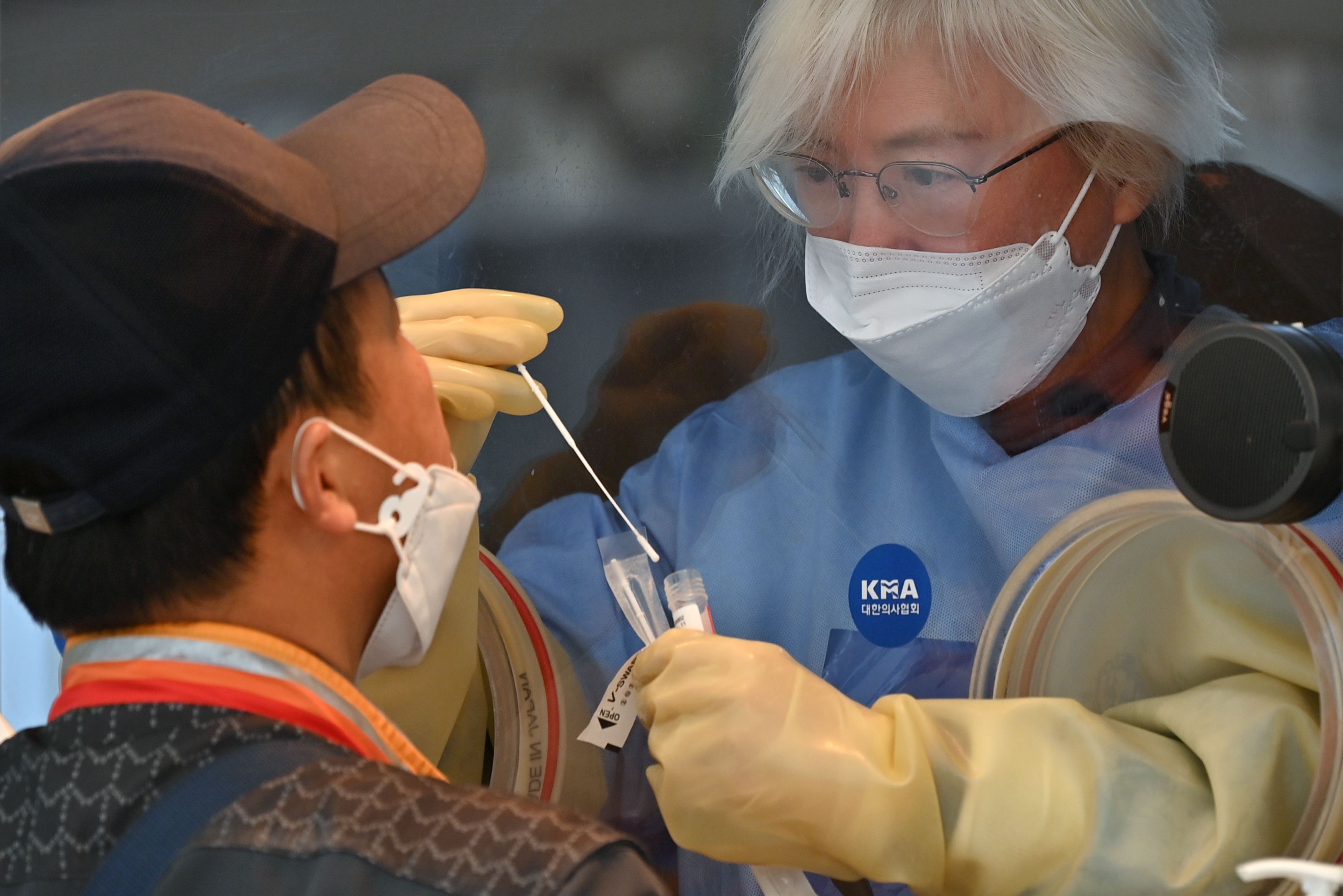 Petugas kesehatan sedang melakukan tes swab di Seoul. 