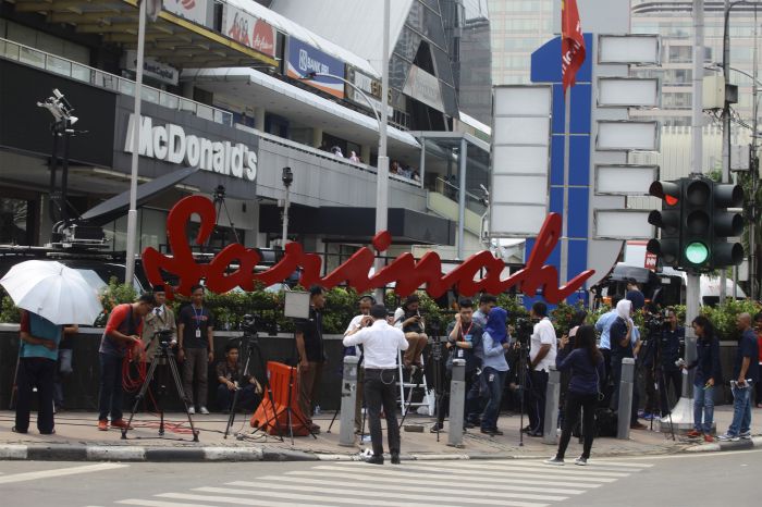 Sejumlah wartawan melakukan aktivitas di depan Gedung Sarinah, Jakarta.