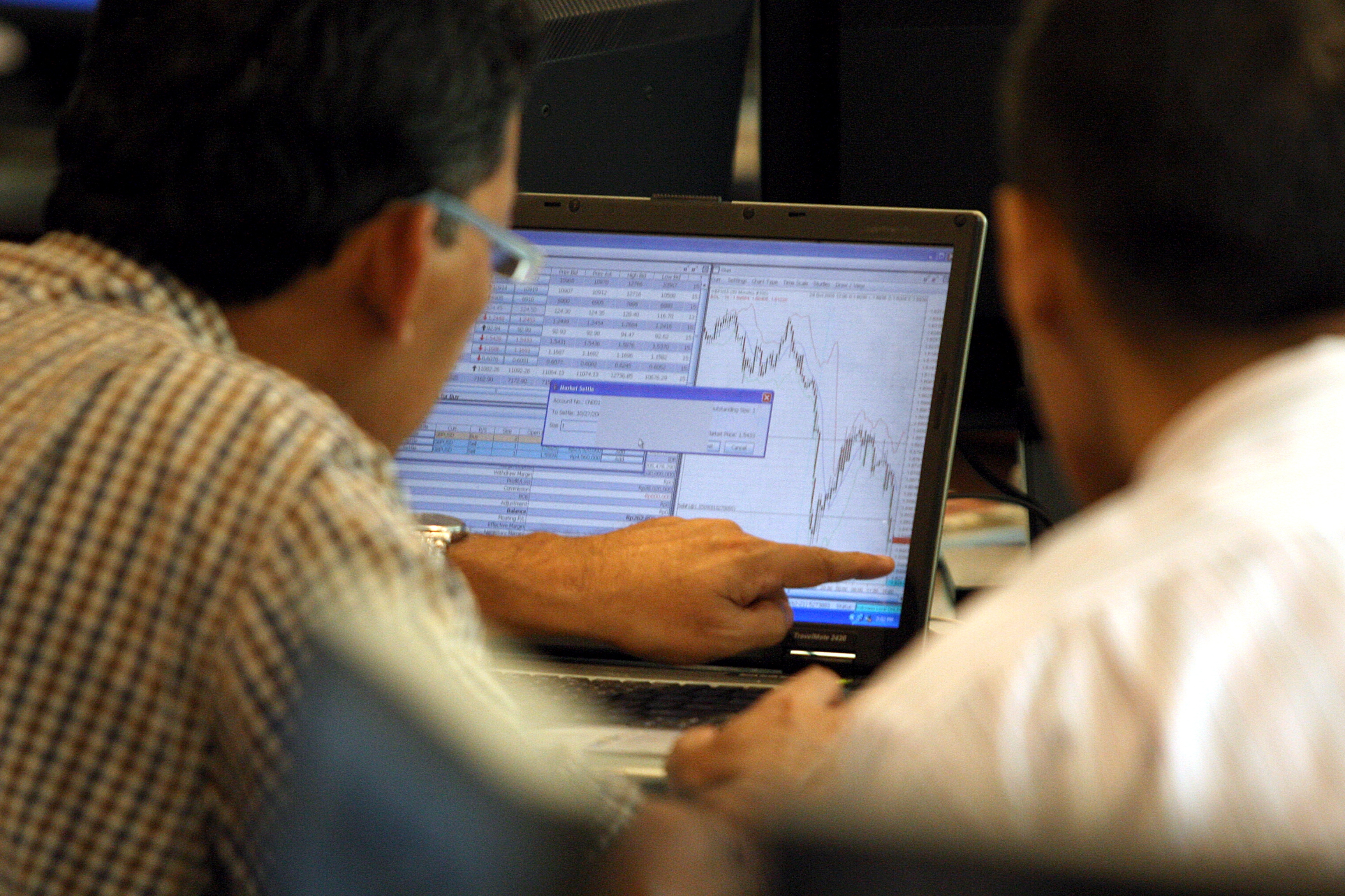 Dua broker berdiskusi dan mengamati pergerakan saham, beberapa waktu lalu.