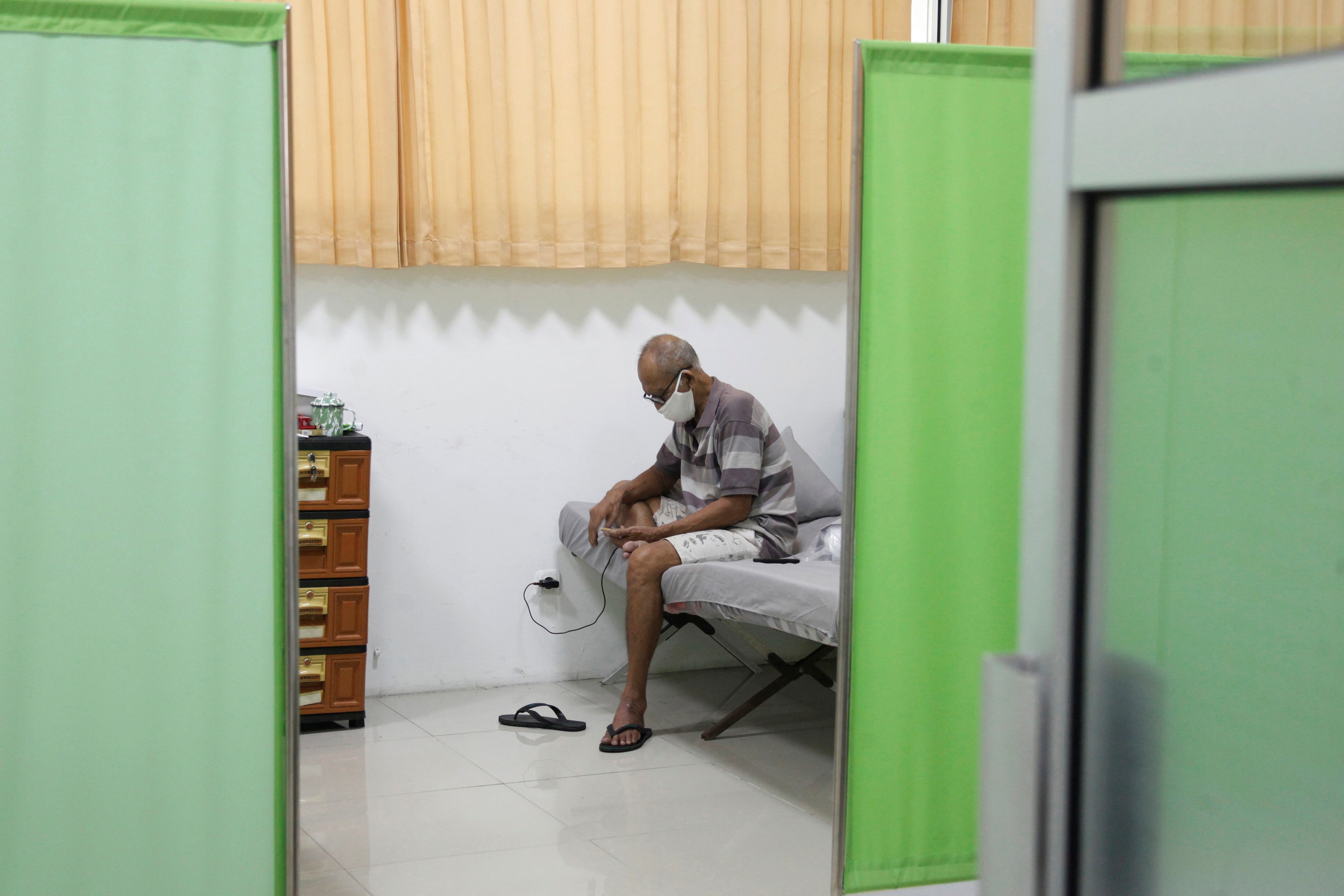 Pemudik menggunakan telepon genggam saat menghuni tempat karantina khusus di Solo Technopark, Jebres, Solo, beberapa waktu lalu.