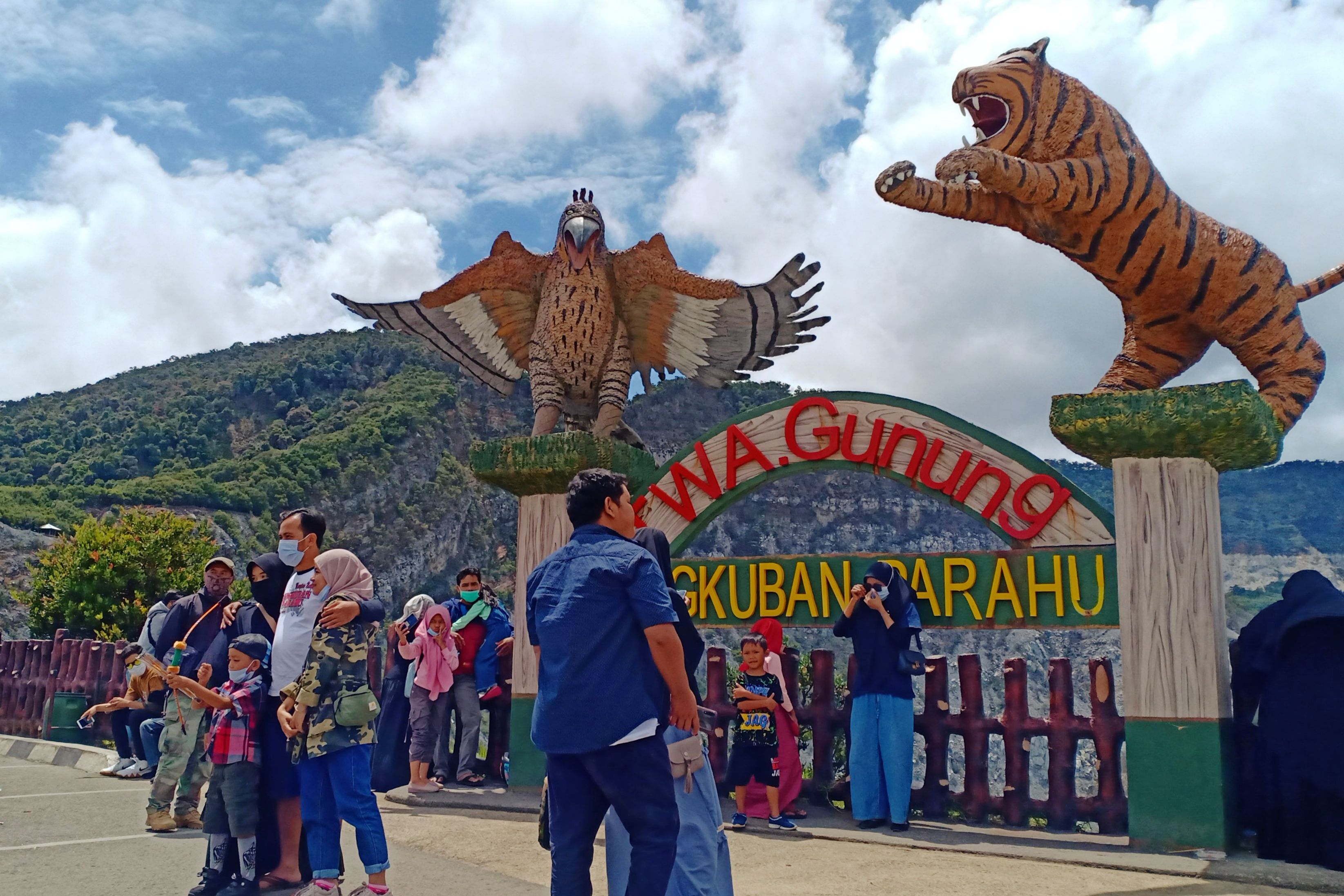 Wisatawan berfoto dengan latar kawah Tangkuban Parahu, Minggu (3/1).