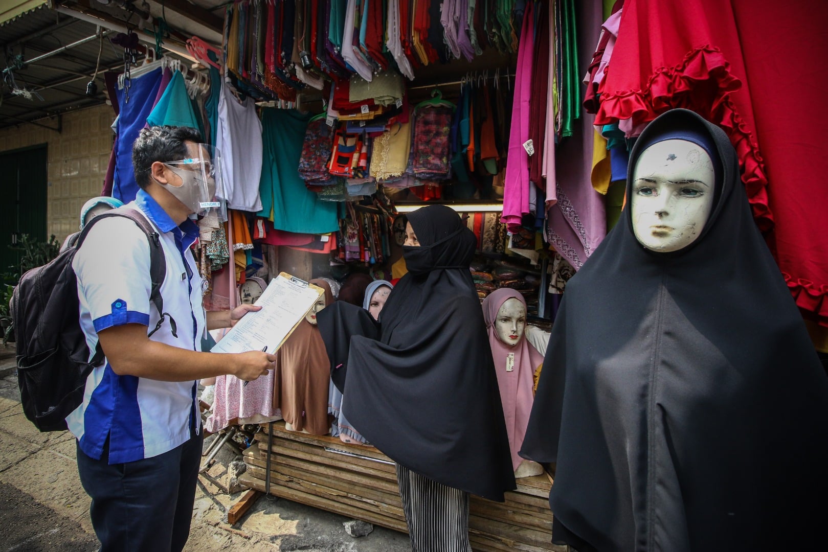 Petugas Antar Jemput Izin Bermotor (AJIB) memberikan penjelasan tentang perizinan kepada pedagang UMKM