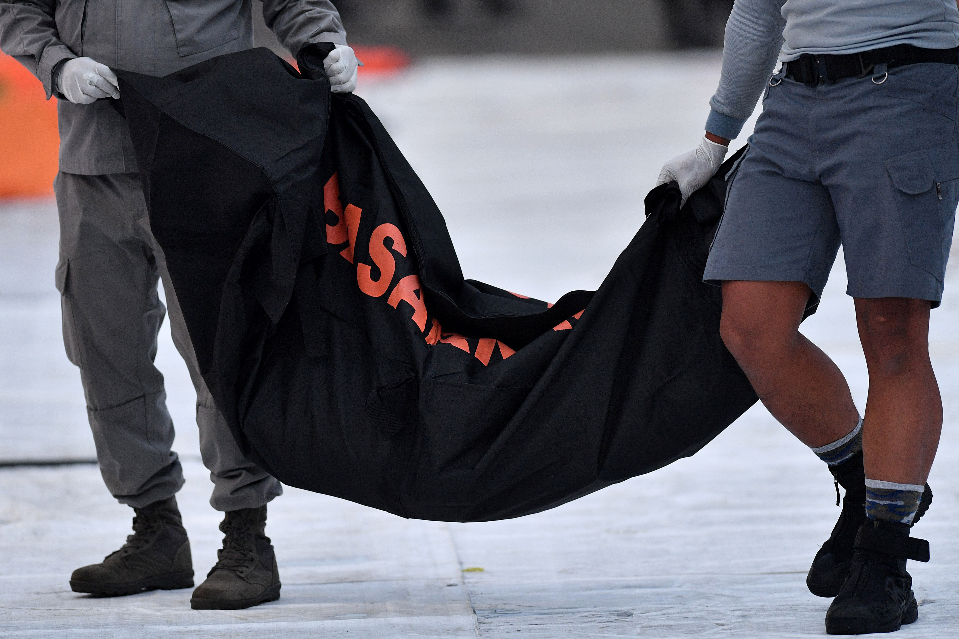 Anggota Bakamla membawa kantong jenazah korban kecelakaan Sriwijaya di Dermaga JICT, Tanjung Priok, Jakarta Utara, Rabu (13/1).