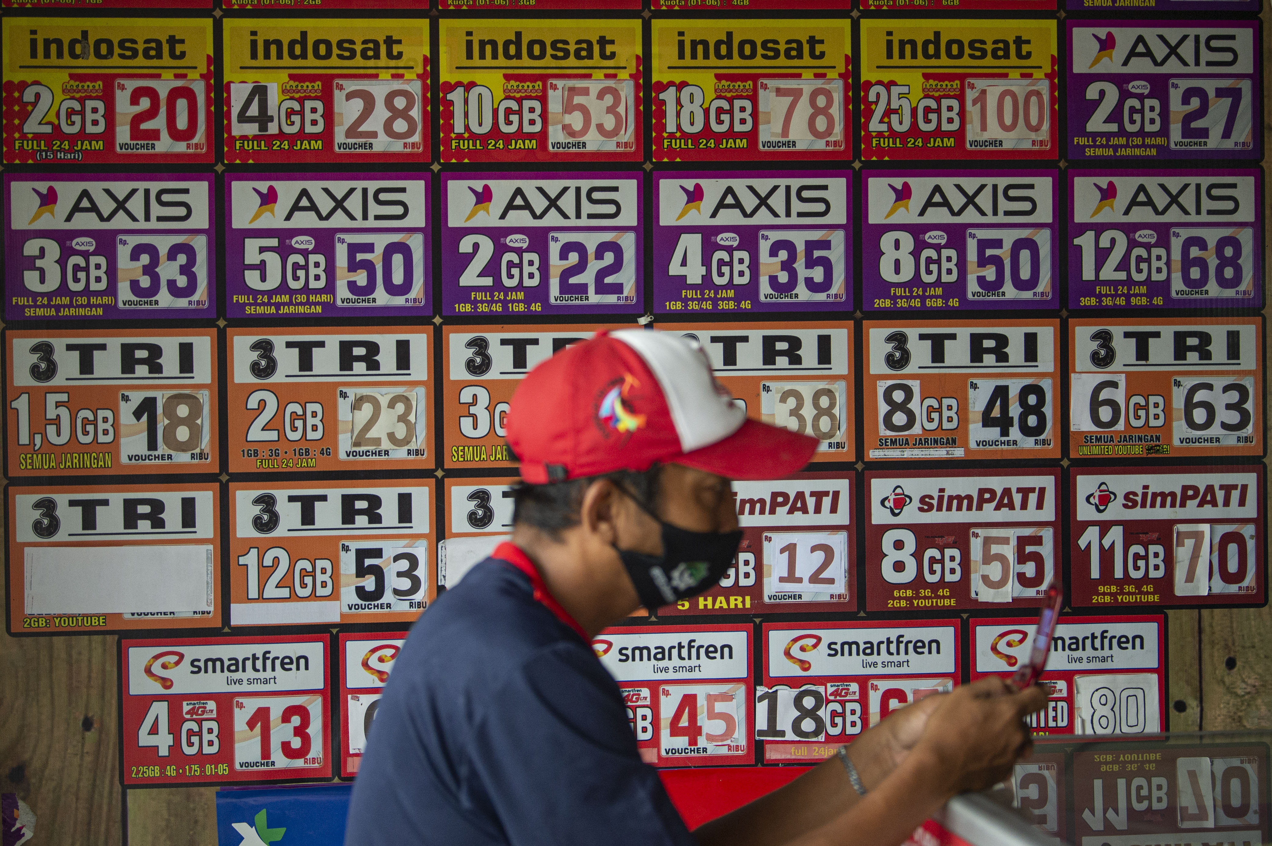 Konsumen membeli voucher pulsa seluler. 