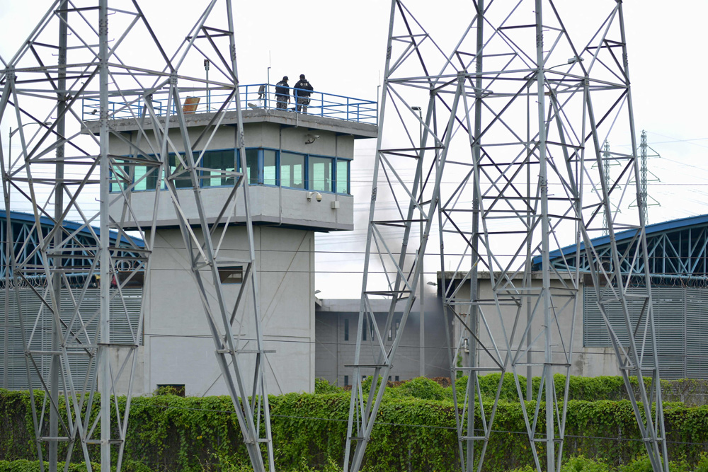 Dua petugas terlihat melakukan penjagaan di penjara di Kota Guayaquil, Ekuador setelah terjadi kerusuhan antarnapi. 