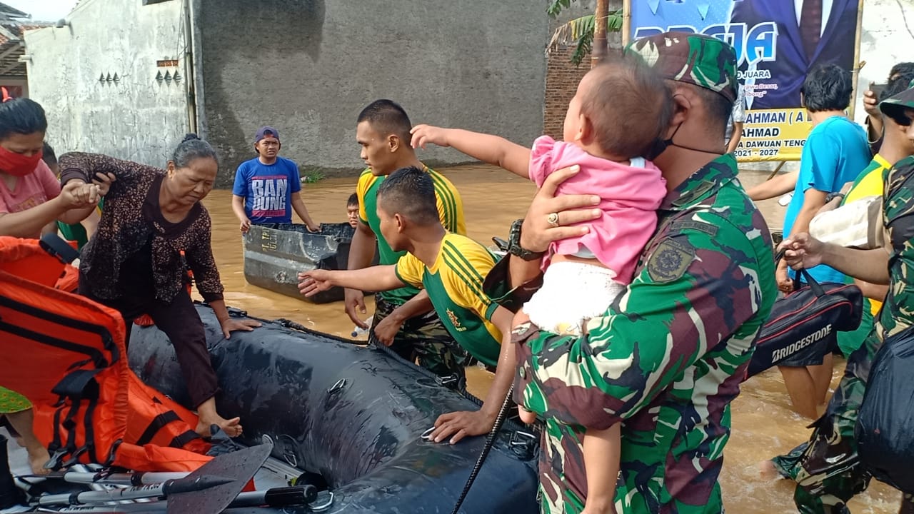 Anggota Yonif Para Raider Divif 1 Kostrad, Minggu (7/2) mengirim tim evakuasi untuk membantu korban banjir di Desa Dawuan, Cikampek. 