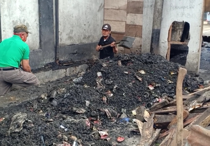  Warga mengeruk tanah yang mengendap di saluran drainase di sekitar Pasar Panorama Lembang, Kabupaten Bandung Barat, Kamis (4/2/2021).