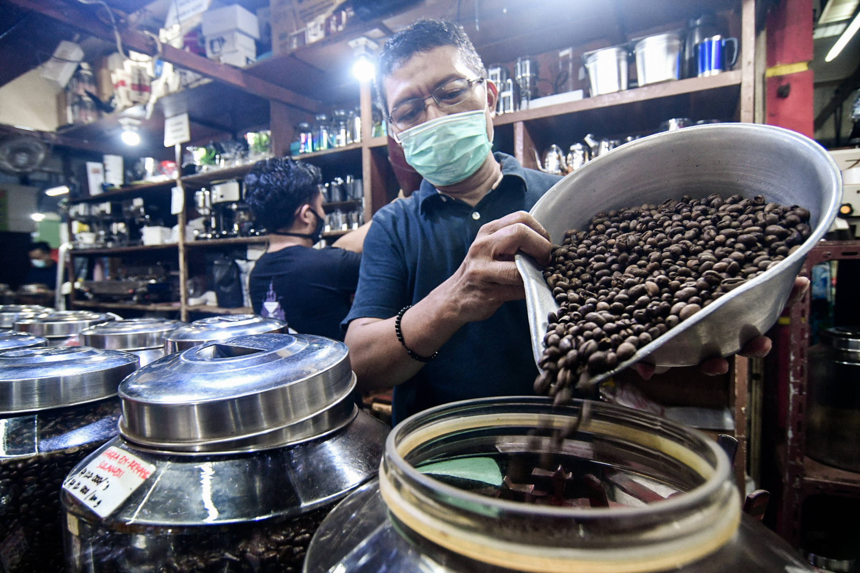 Pekerja menyortir biji kopi di gerai yang berlokasi di Pasar Santa, Jakarta.