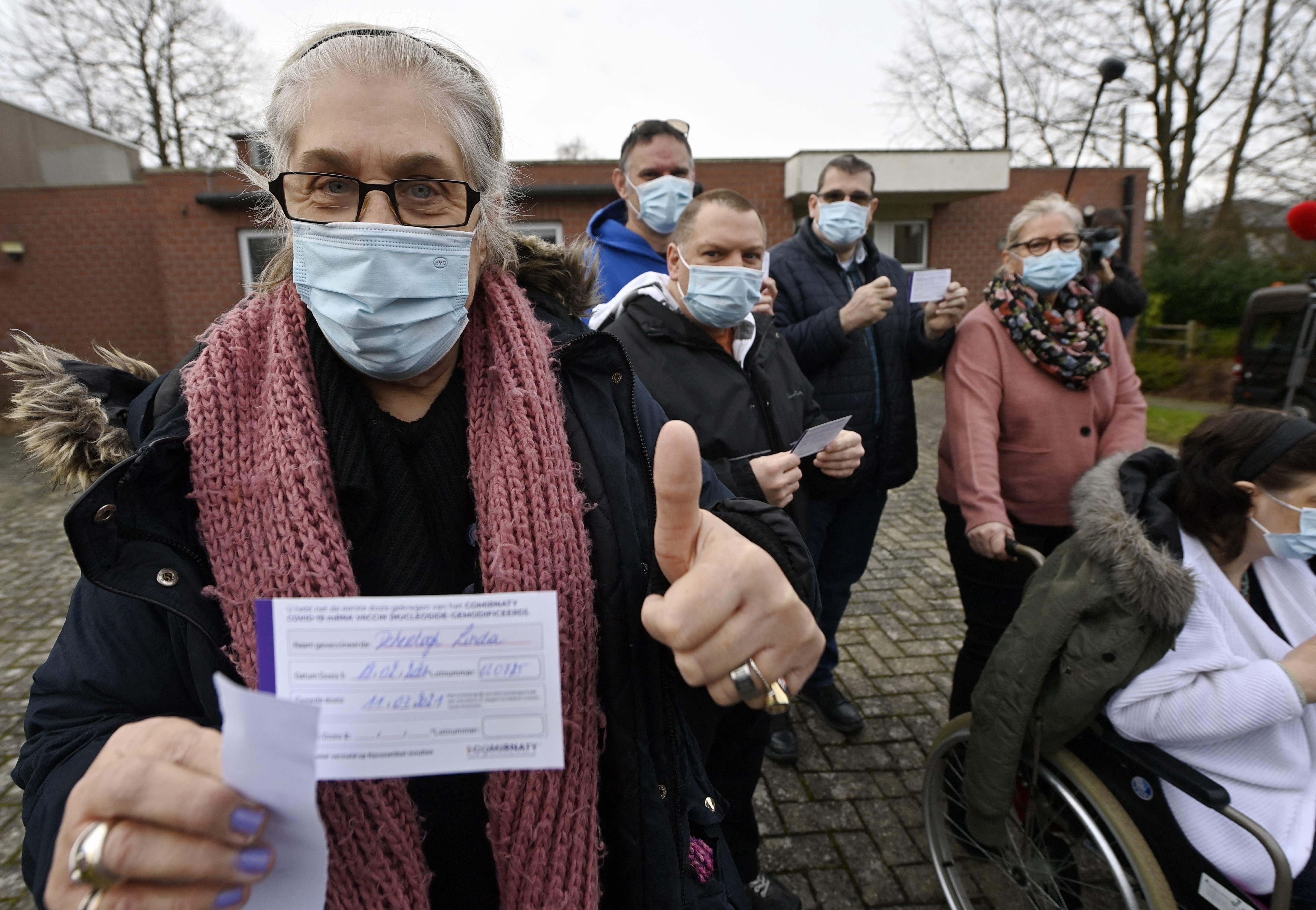 Seorang perempuan menunjukkan sertifikat vaksinasi covid-19 di Overijse, Belgia.
