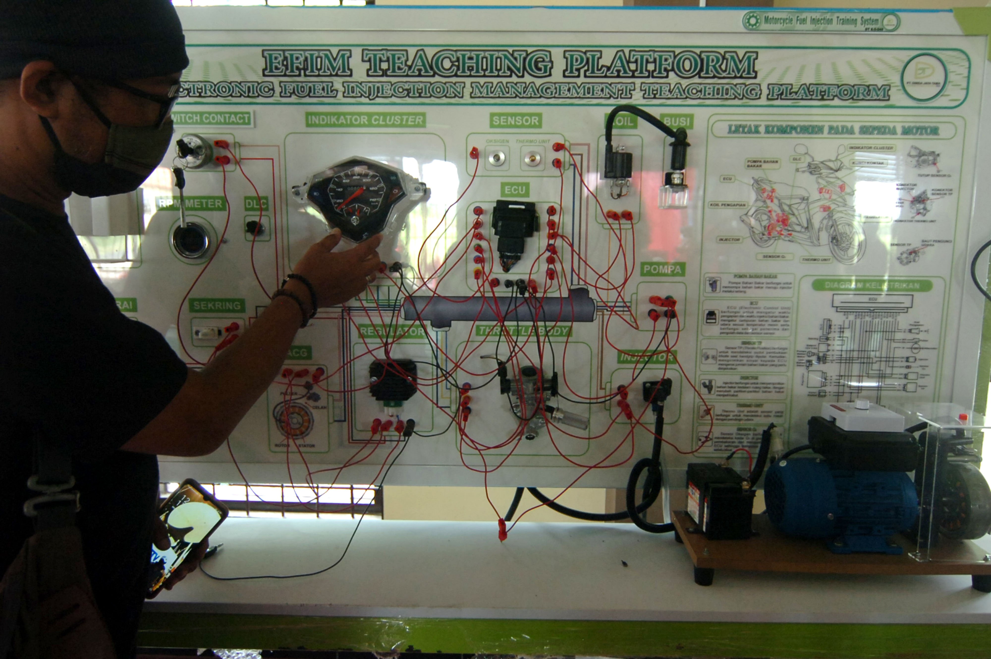 Warga melihat perlatan otomotif di salah satu Balai Latihan Kerja di Tegal, Jawa Tengah