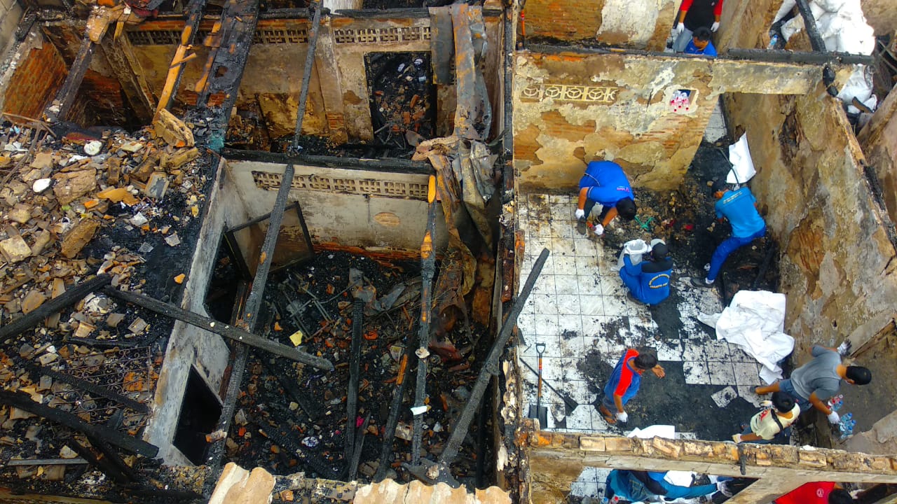 Petugas membersihkan puing sisa kebakaran yang melanda 23 rumah yang berada di Jalan Penegak I, RT 004/001 Kelurahan Palmeriam, Jumat.