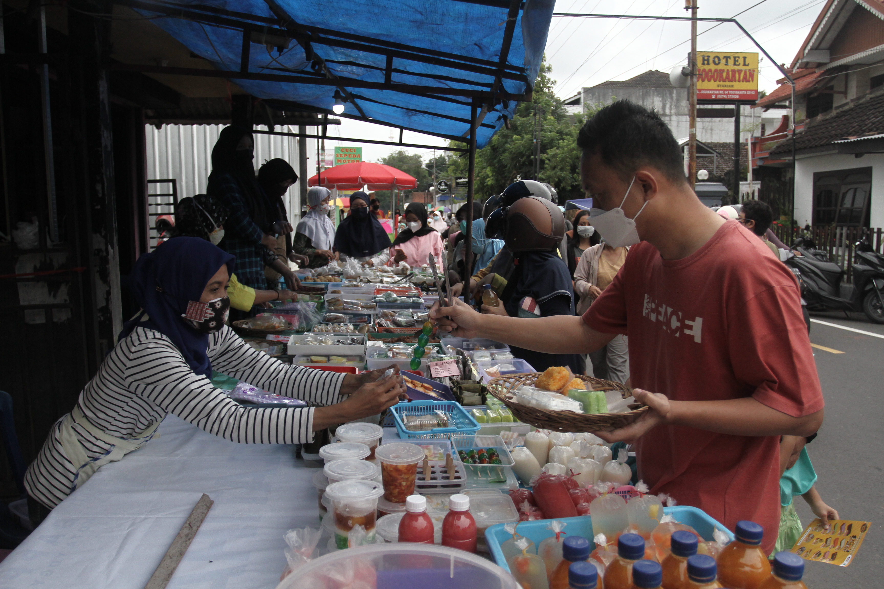 Warga membeli makanan untuk berbuka puasa di Kampung Ramadan Jogokariyan, Mantrijeron, Yogyakarta, Rabu (13/4/2021) dengan prokes. 
