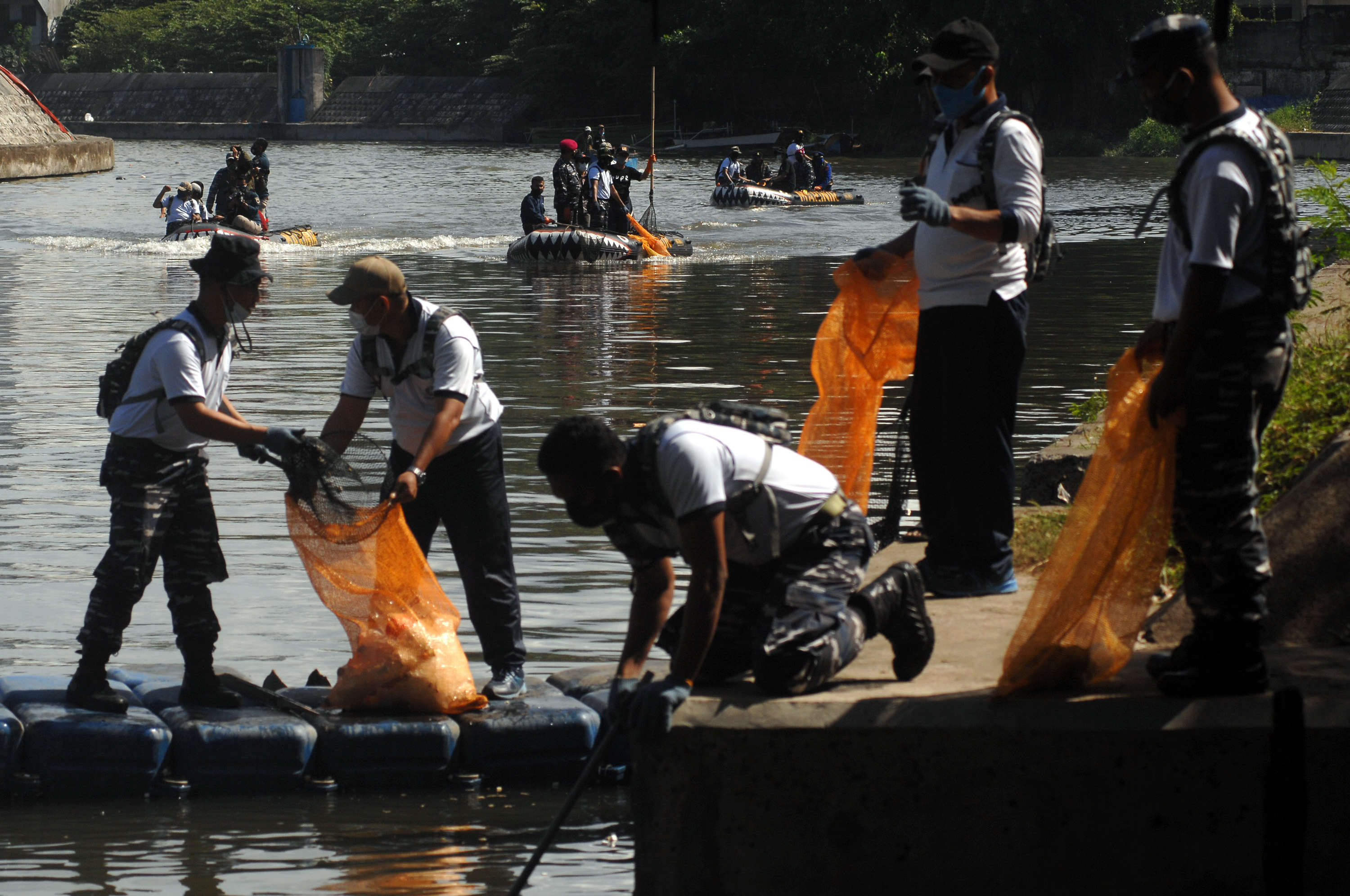  Sejumlah prajurit TNI AL membersihkan sampah di sepanjang Daerah Aliran Sungai (DAS) Tondano di Manado, Sulawesi Utara, Kamis (18/3/2021). 