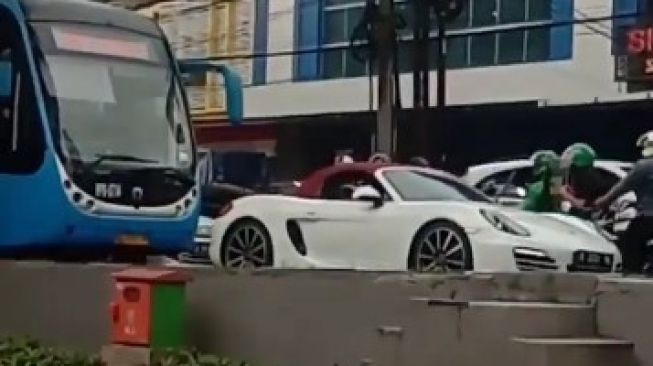 Mobil Porsche yang melanggar peraturan lalu lintas menerobos jalur jalur Trans-Jakarta di Jakarta.