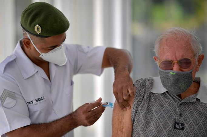 Warga menerima suntikan vaksin covid-19 di Belo Horizonte, Brasil. 