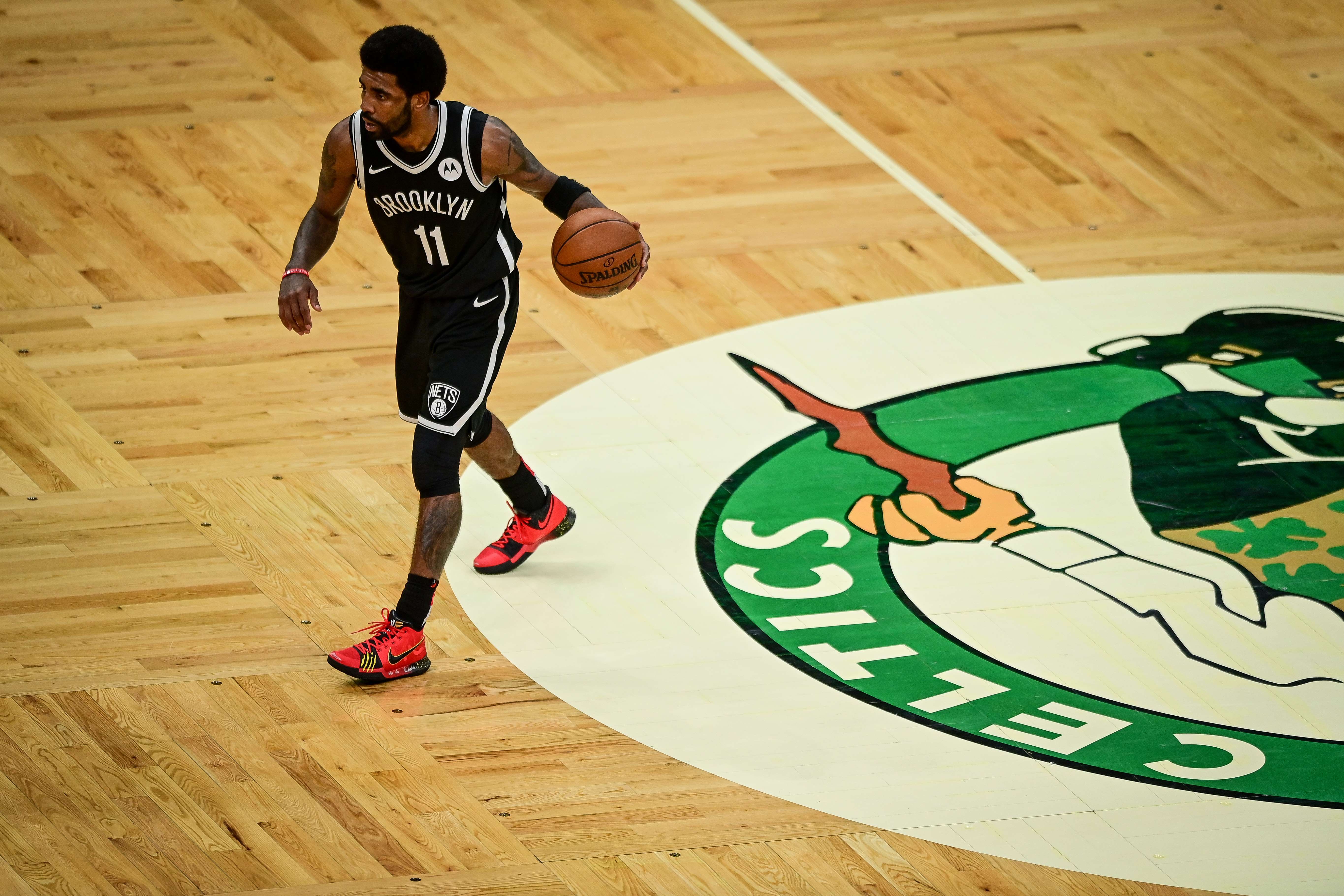 Pemain Brooklyn Nets Kyrie Irving membawa bola dalam laga playoff NBA melawan Boston Celtics.