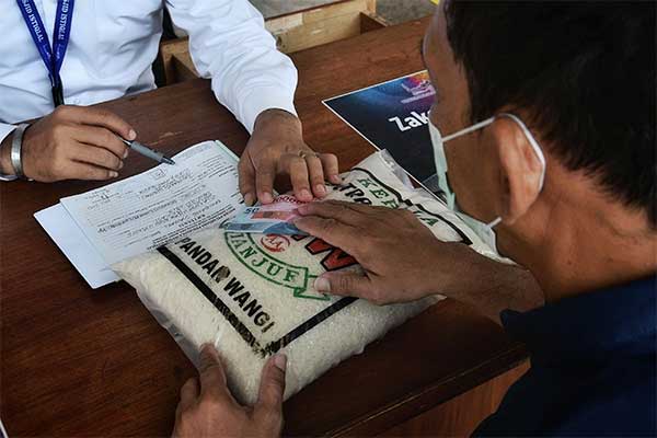 Warga sedang membayar zakat fitrah di sebuah masjid. 