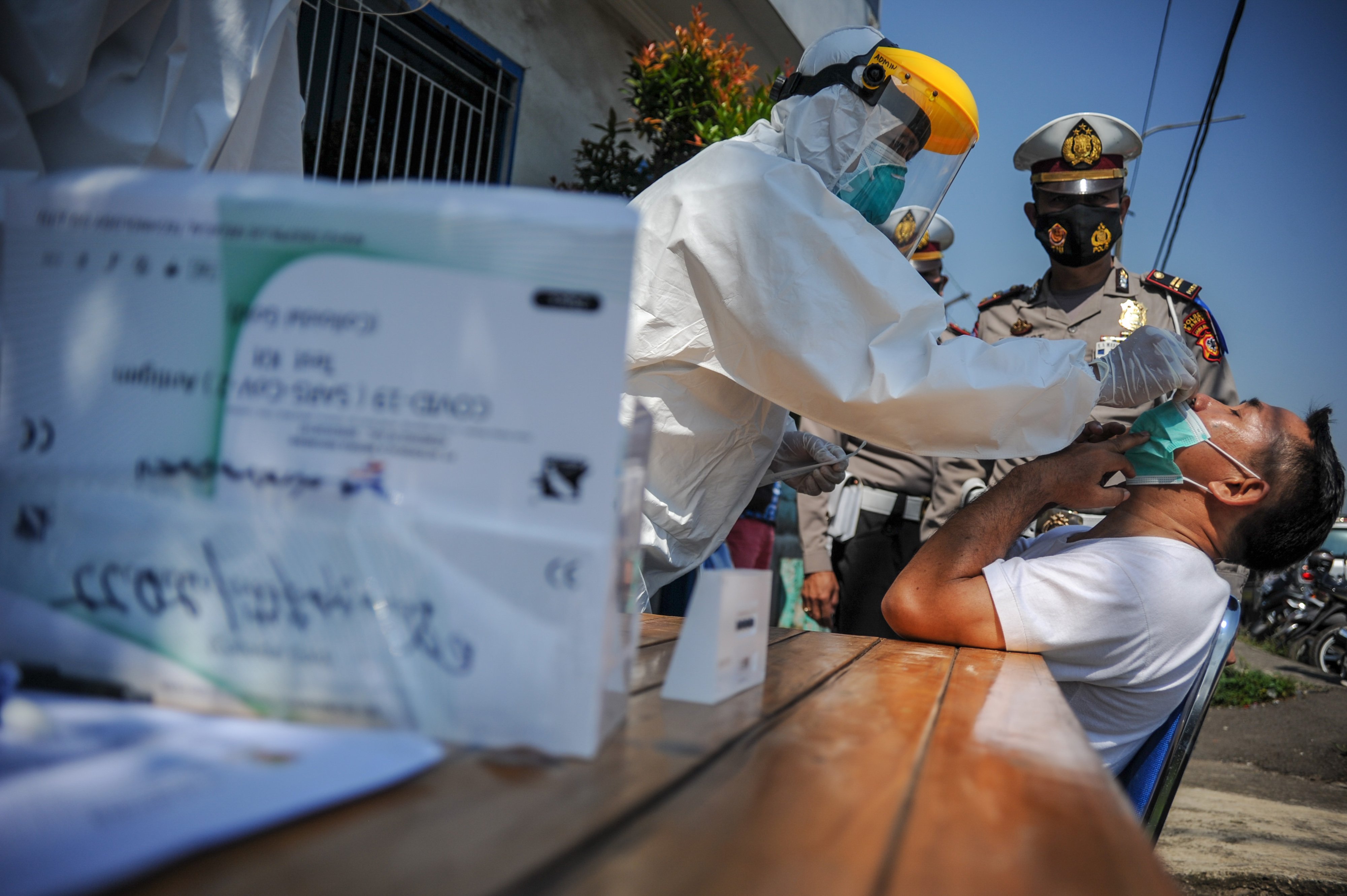 Tenaga kesehatan melakukan swab antigen kepada pemudik